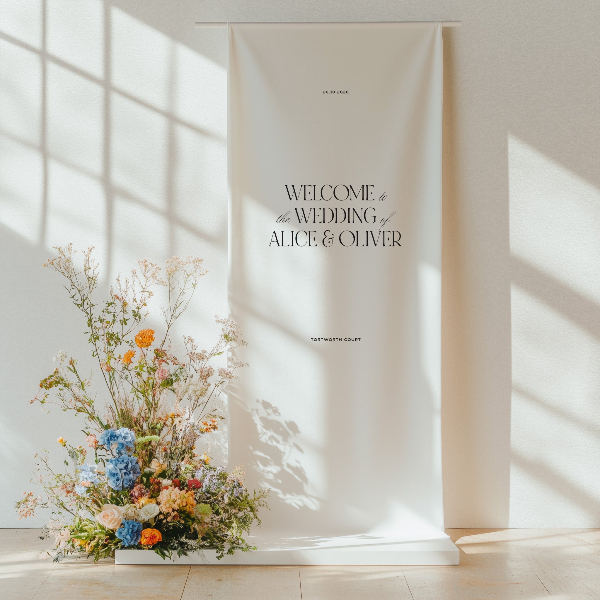 Cotton and linen wedding welcome sign hanging on a stand with floral arrangement