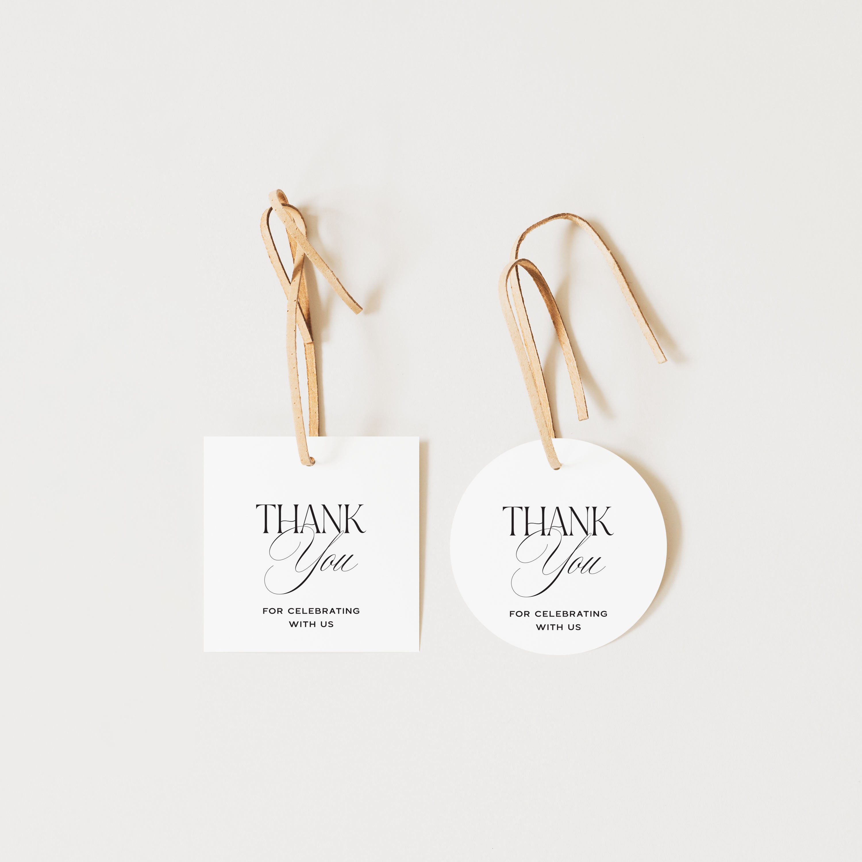 Two white tags with 'Thank You' text on a light background