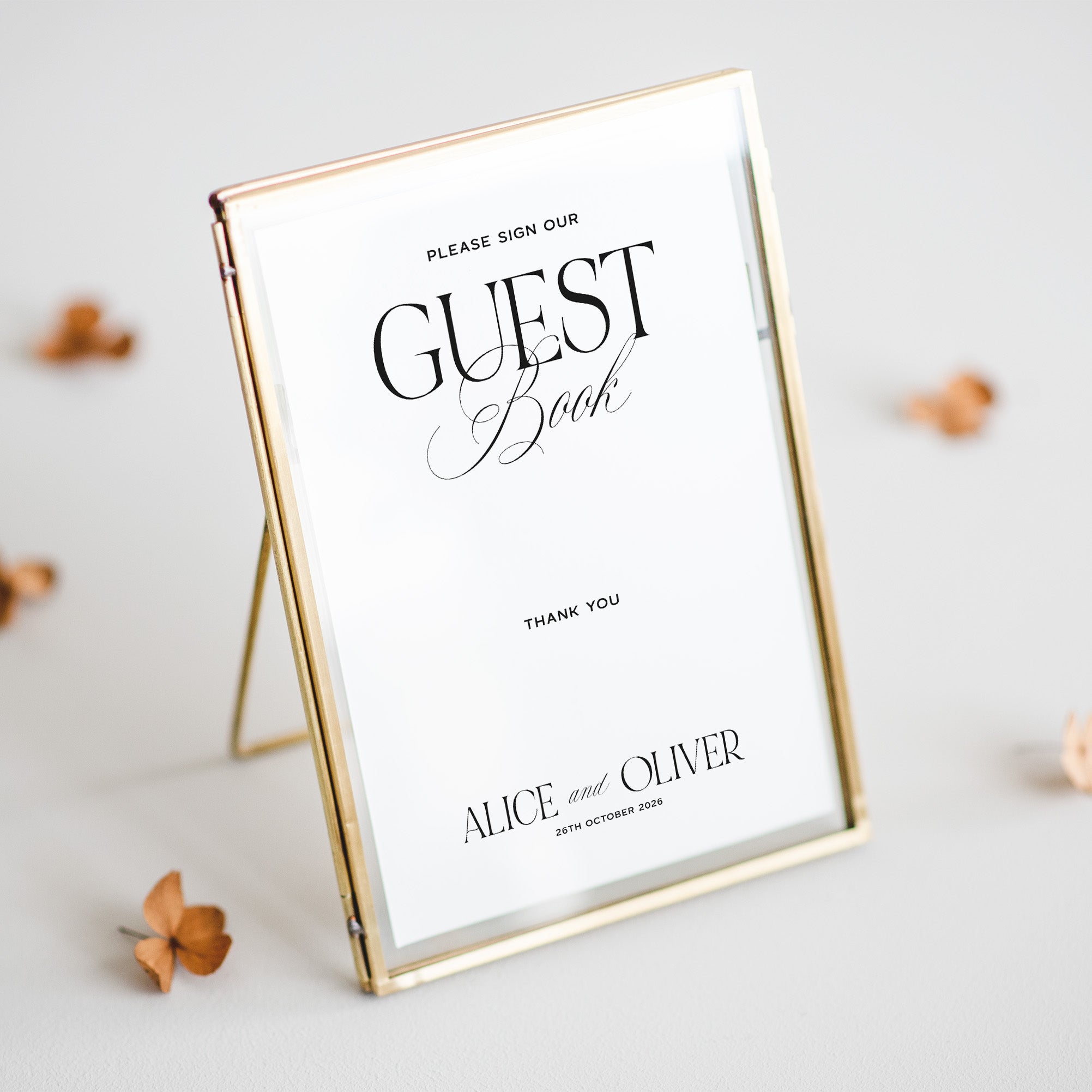 Gold-framed sign for guest book with personalized text on a light background