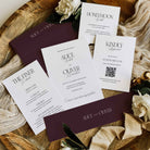 Wedding invitation set with floral decorations on a wooden surface