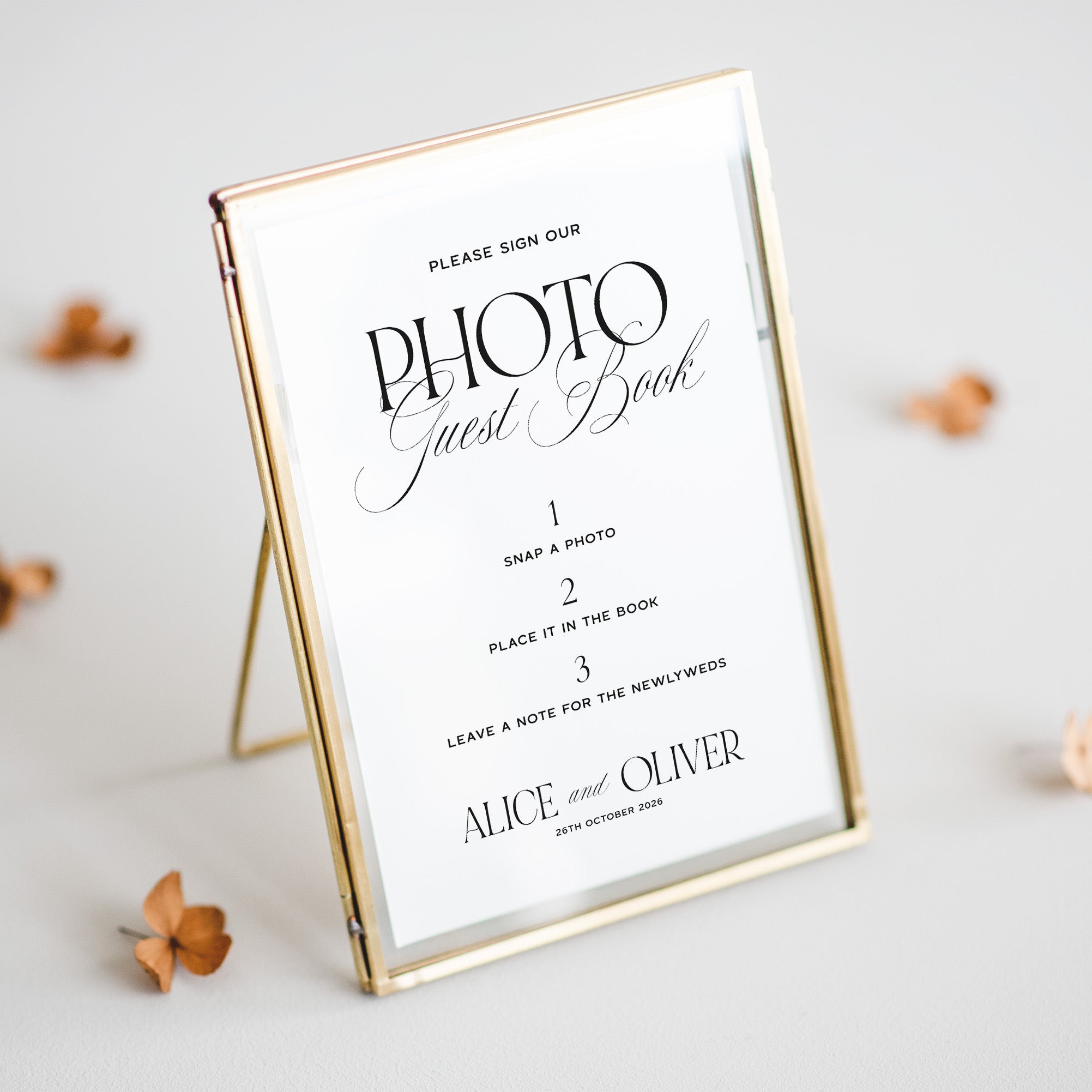 Wedding photo guest book sign with gold frame on a light background