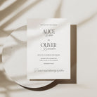 Wedding invitation card on a textured surface with soft shadows