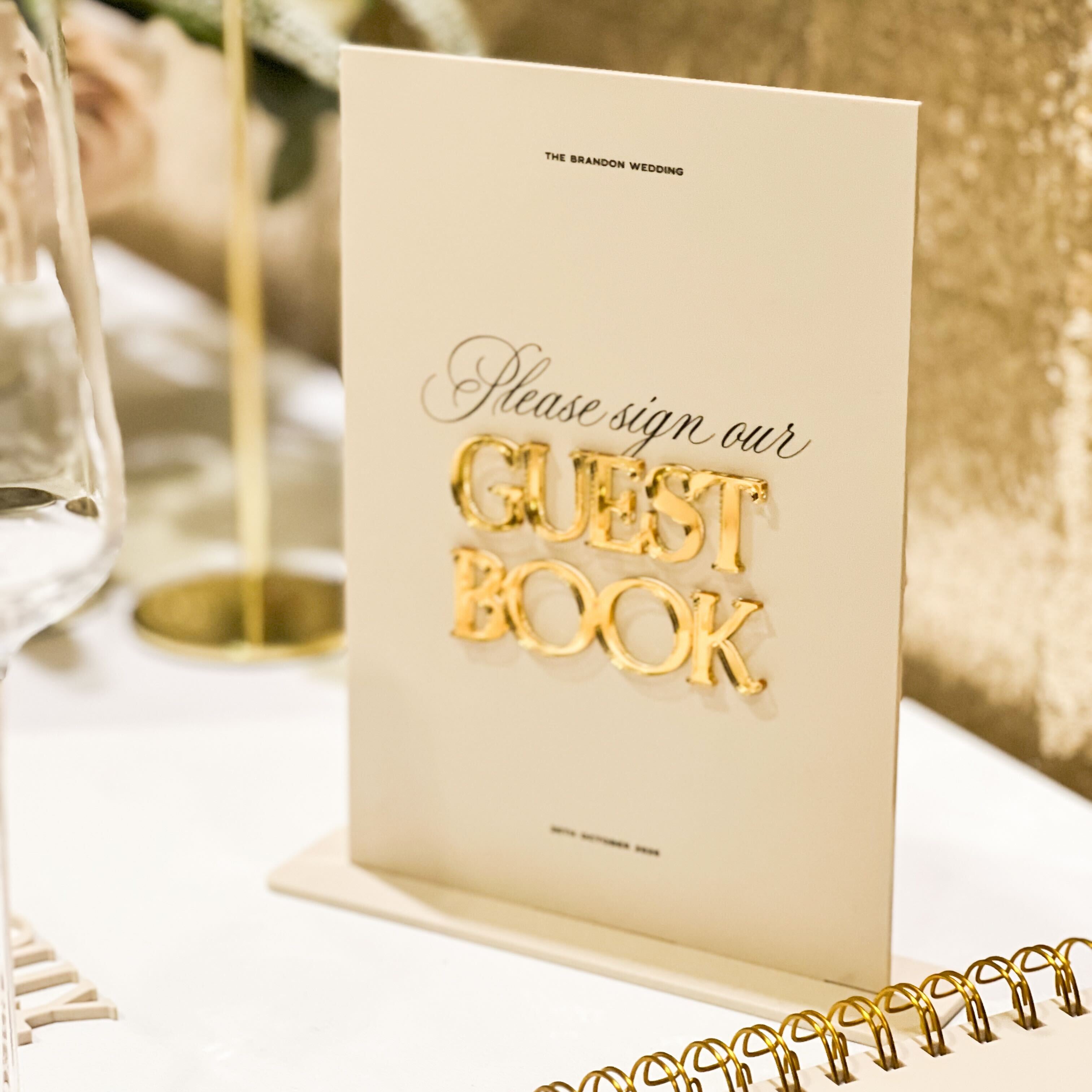 Beige guest book with gold text on a table setting
