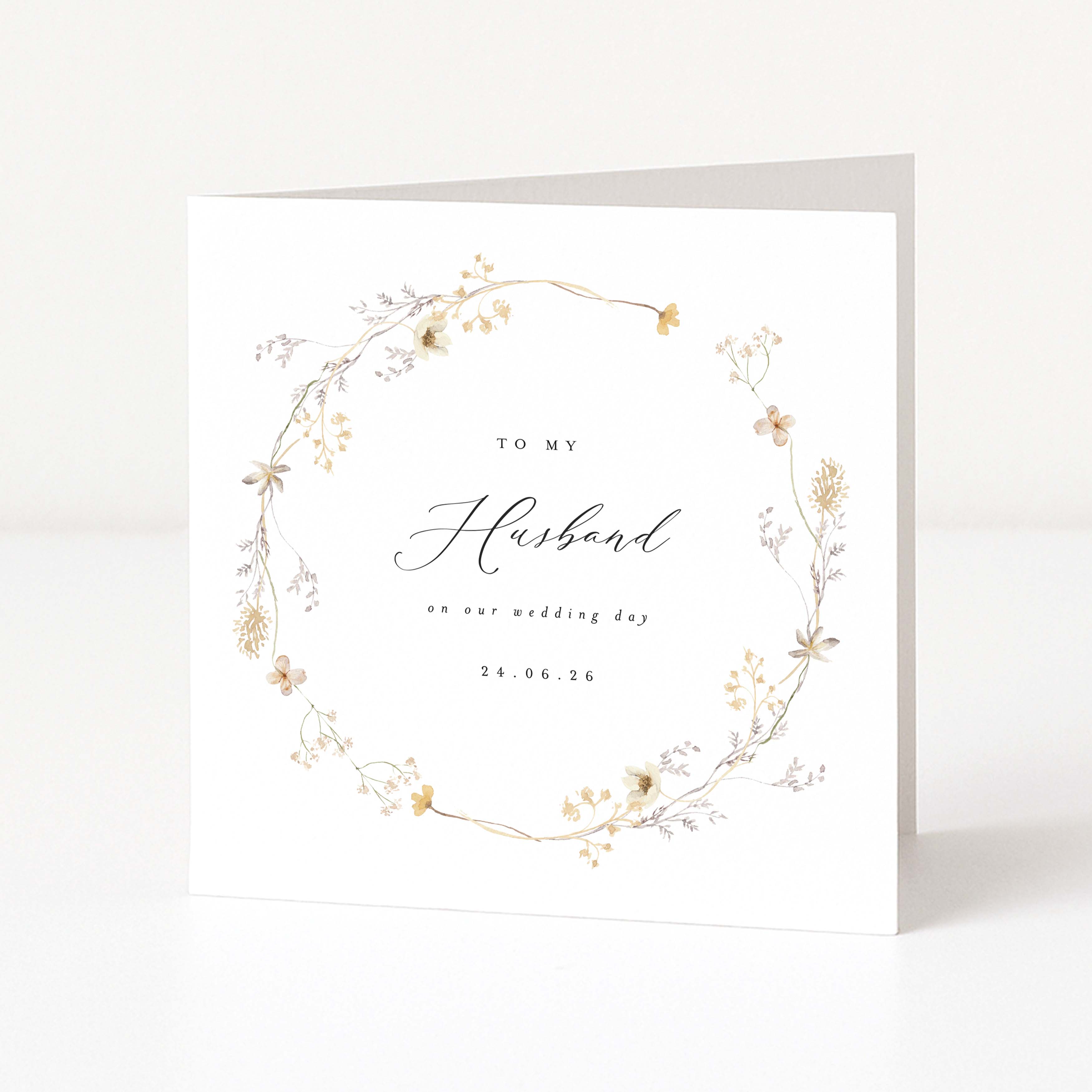 Greeting card with floral wreath and text 'To my Husband on our wedding day' on a white background