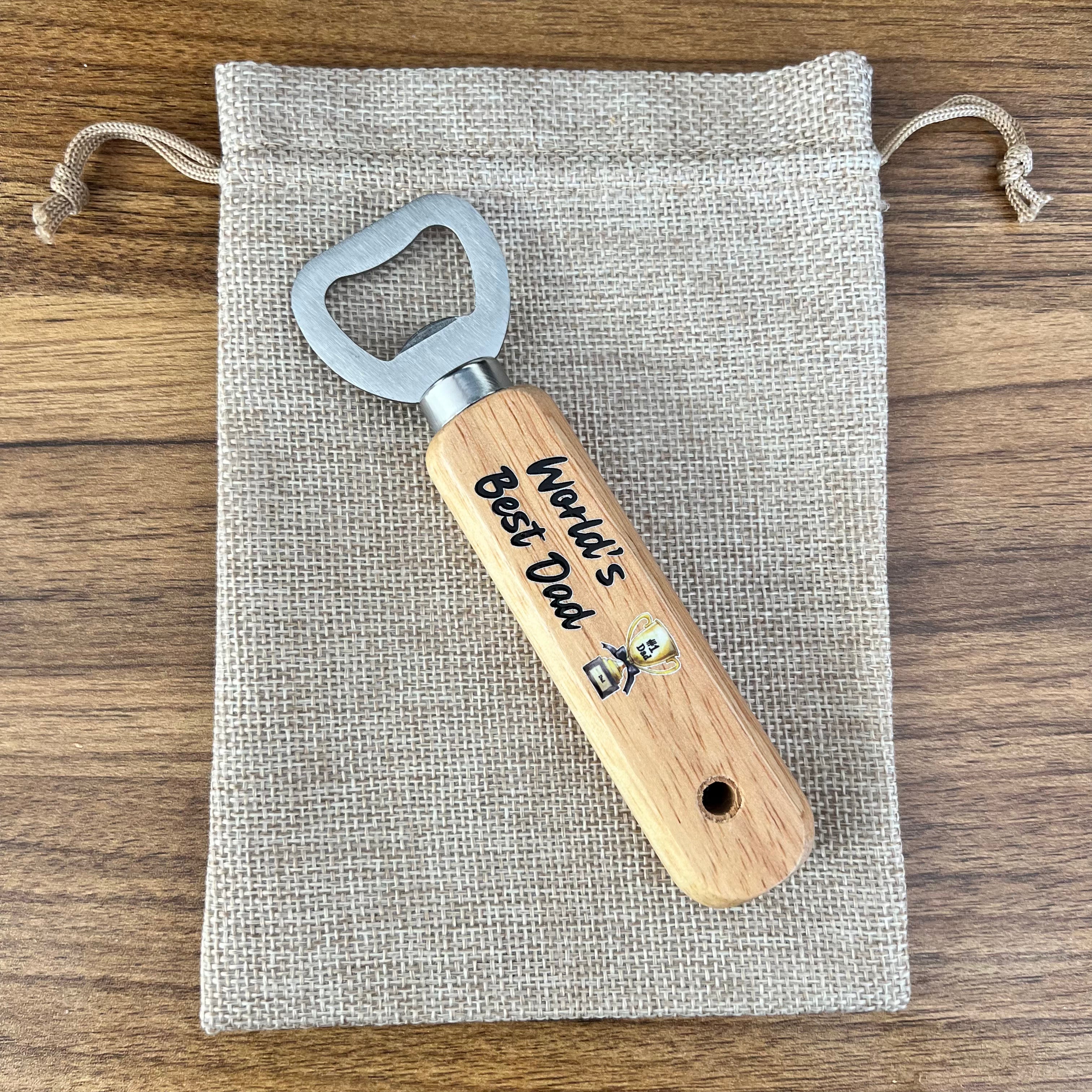 Wooden bottle opener with 'World's Best Dad' engraving on a fabric pouch.