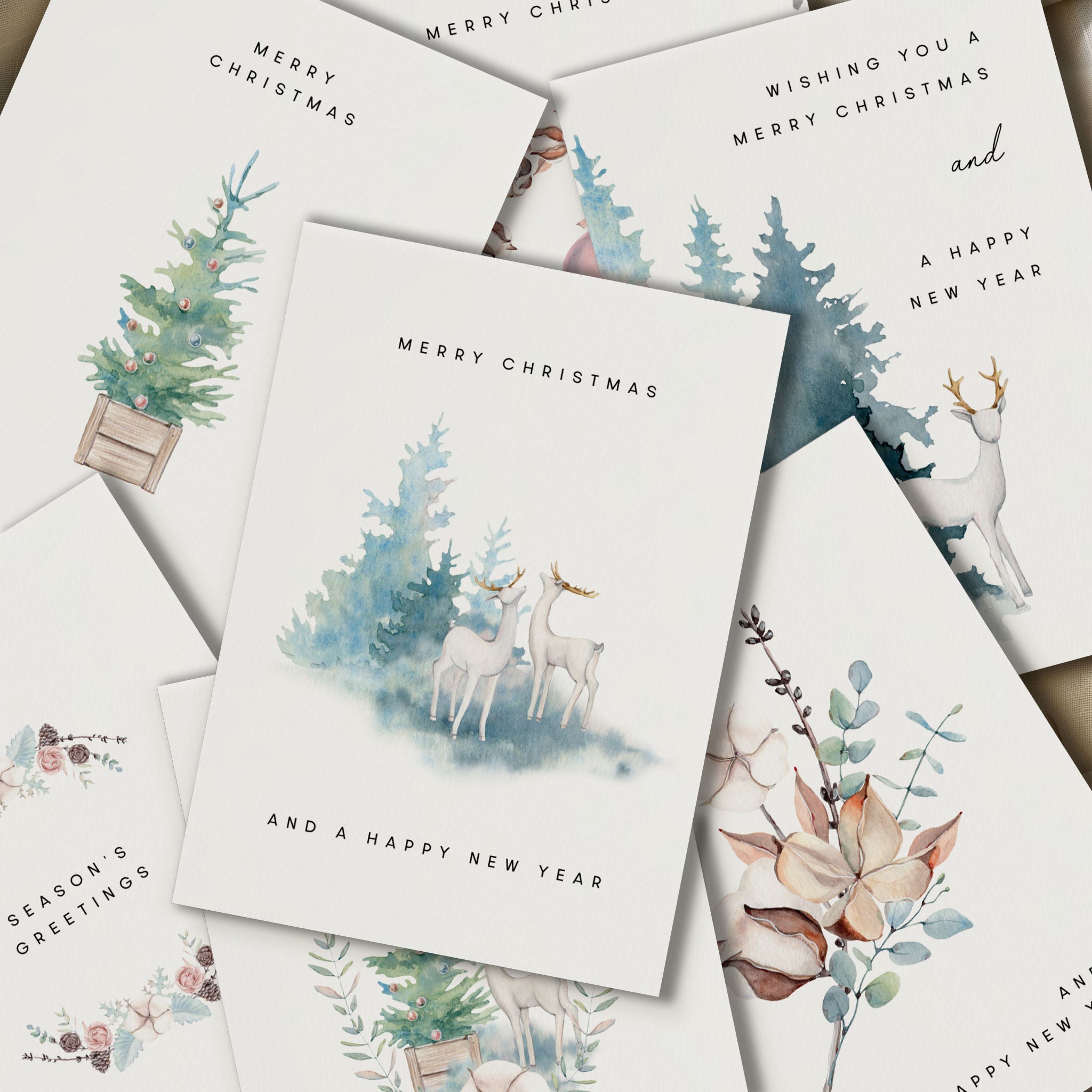 Collection of Christmas cards with nature-themed designs featuring trees, deer, and foxes.