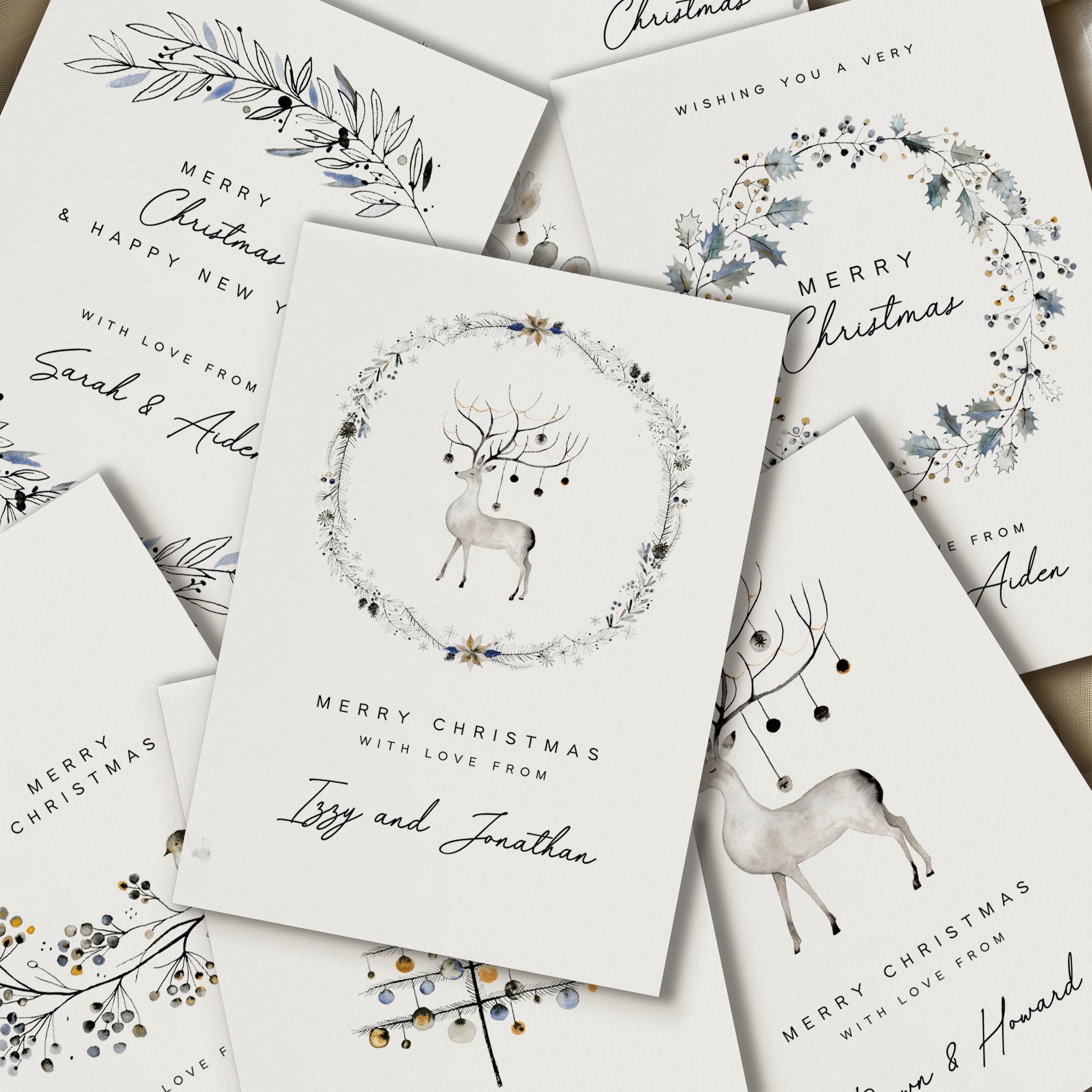 Collection of personalized Christmas cards with reindeer and floral designs.