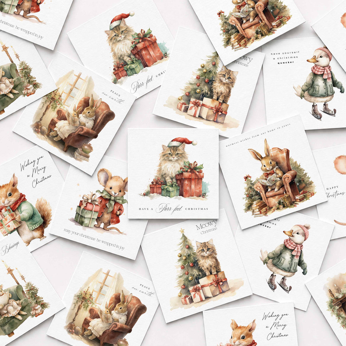 A scattered arrangement of vintage-style Christmas greeting cards featuring illustrated animals such as rabbits, mice, a squirrel, and a goose around Christmas trees, gifts, and cozy holiday scenes on a white background.