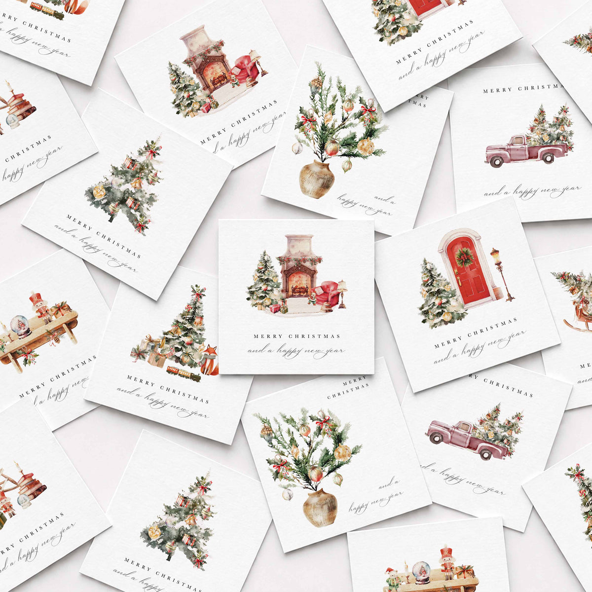 A scattered arrangement of square Christmas greeting cards on a light background. Each card features a delicate watercolor-style illustration, including a fireplace with a red sleigh, decorated trees, vintage trucks, and holiday motifs, with the text 'MERRY CHRISTMAS and a happy winter' in cursive script.