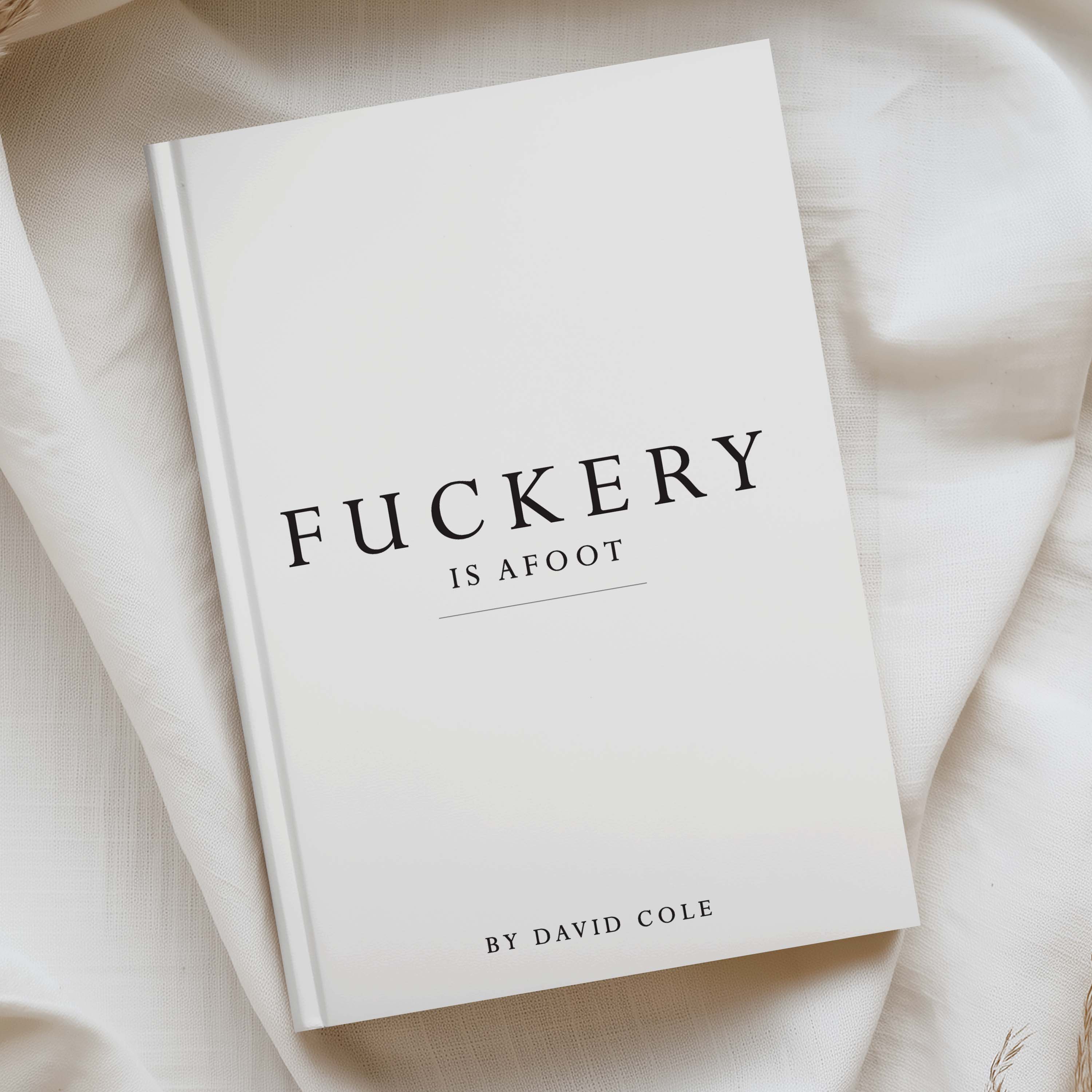 A hardcover book titled 'FUCKERY IS AFOOT' by David Cole, displayed on a soft, draped cream-colored fabric background.