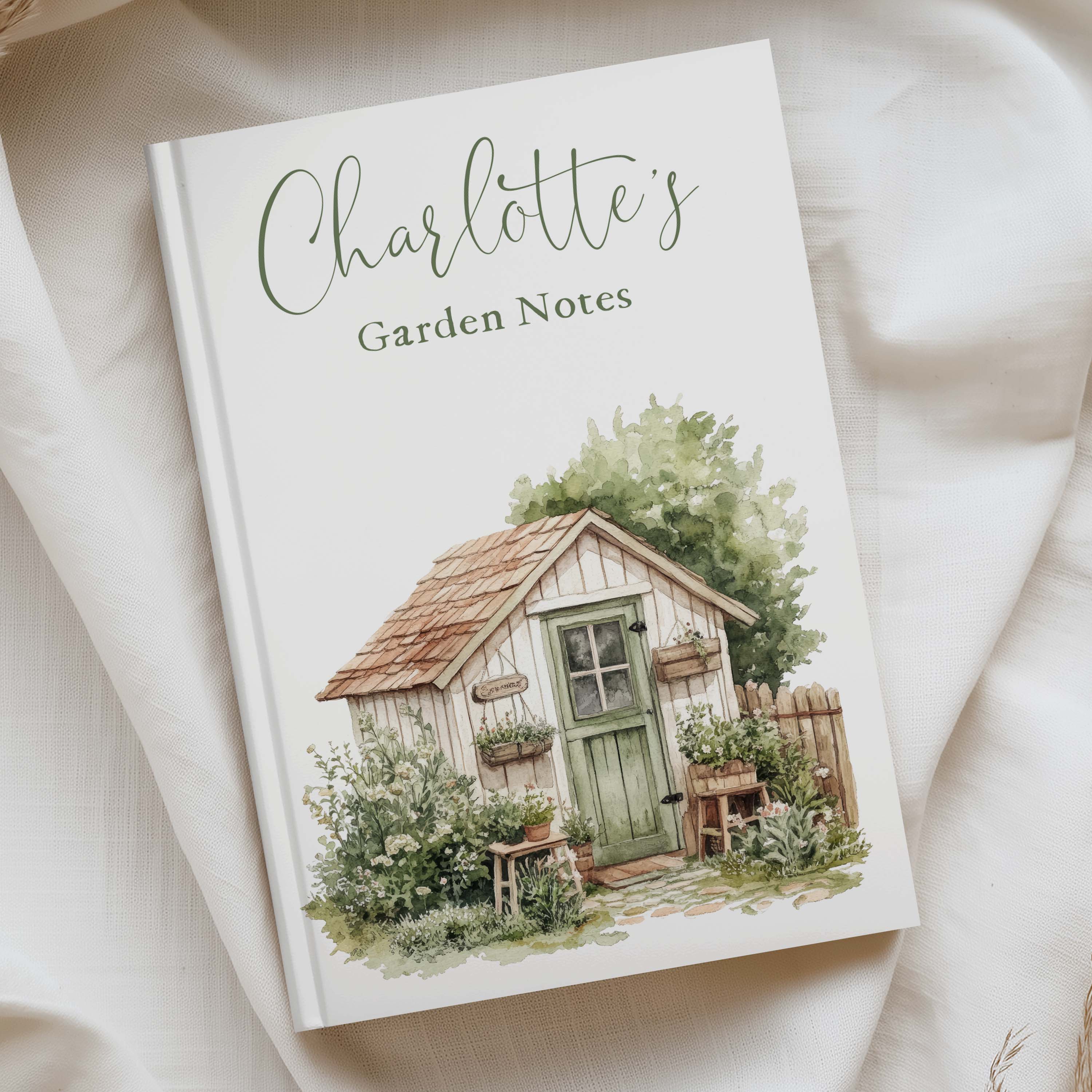 illiustrated a5 notebook with a hardcover that is personalised with charlotte garden notes" in green text.