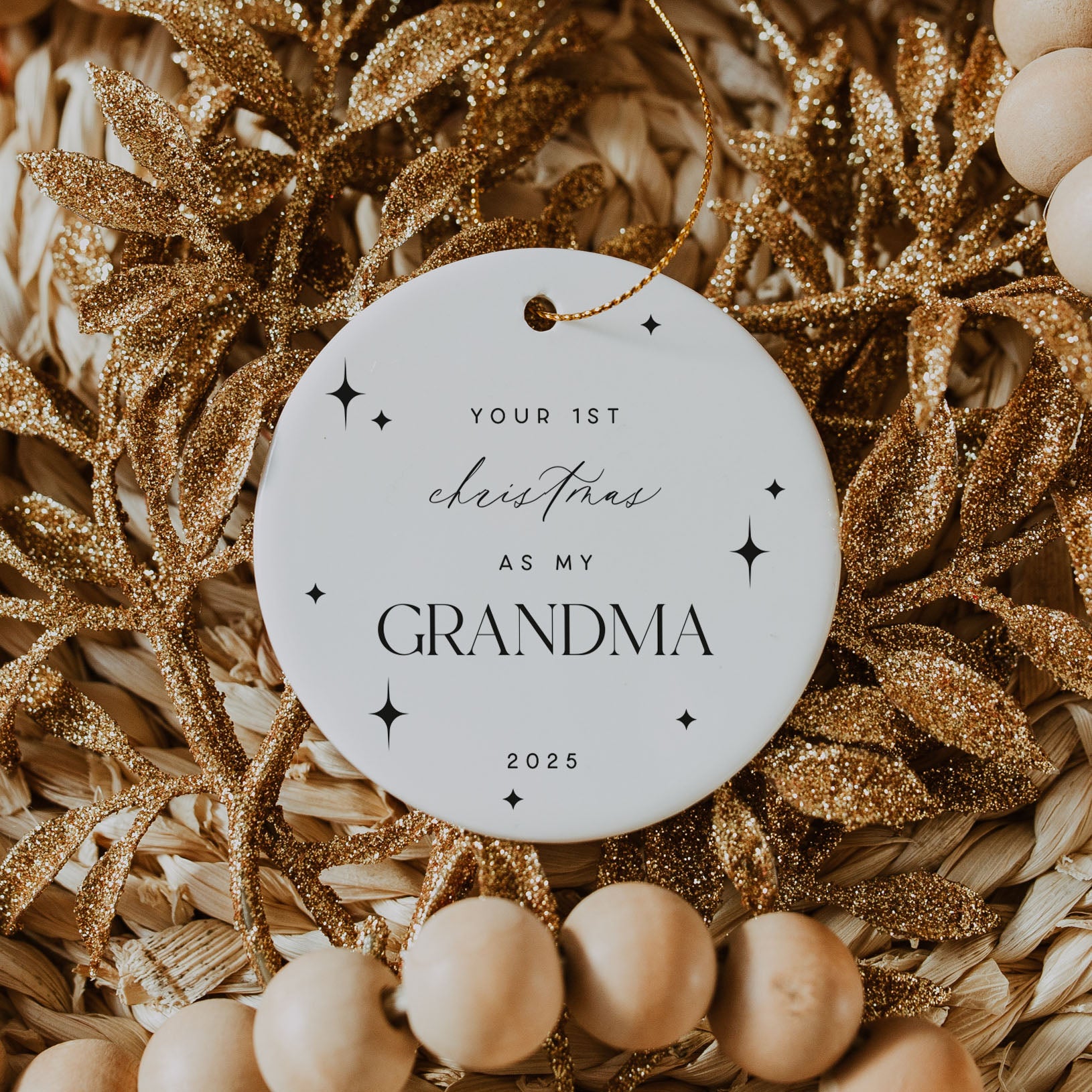 Decorative ornament with 'Your 1st Christmas as my Grandma 2025' text on a gold and beige background.