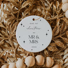 Decorative ornament with 'Our 1st Christmas as Mr & Mrs 2025' text on a gold and beige background.