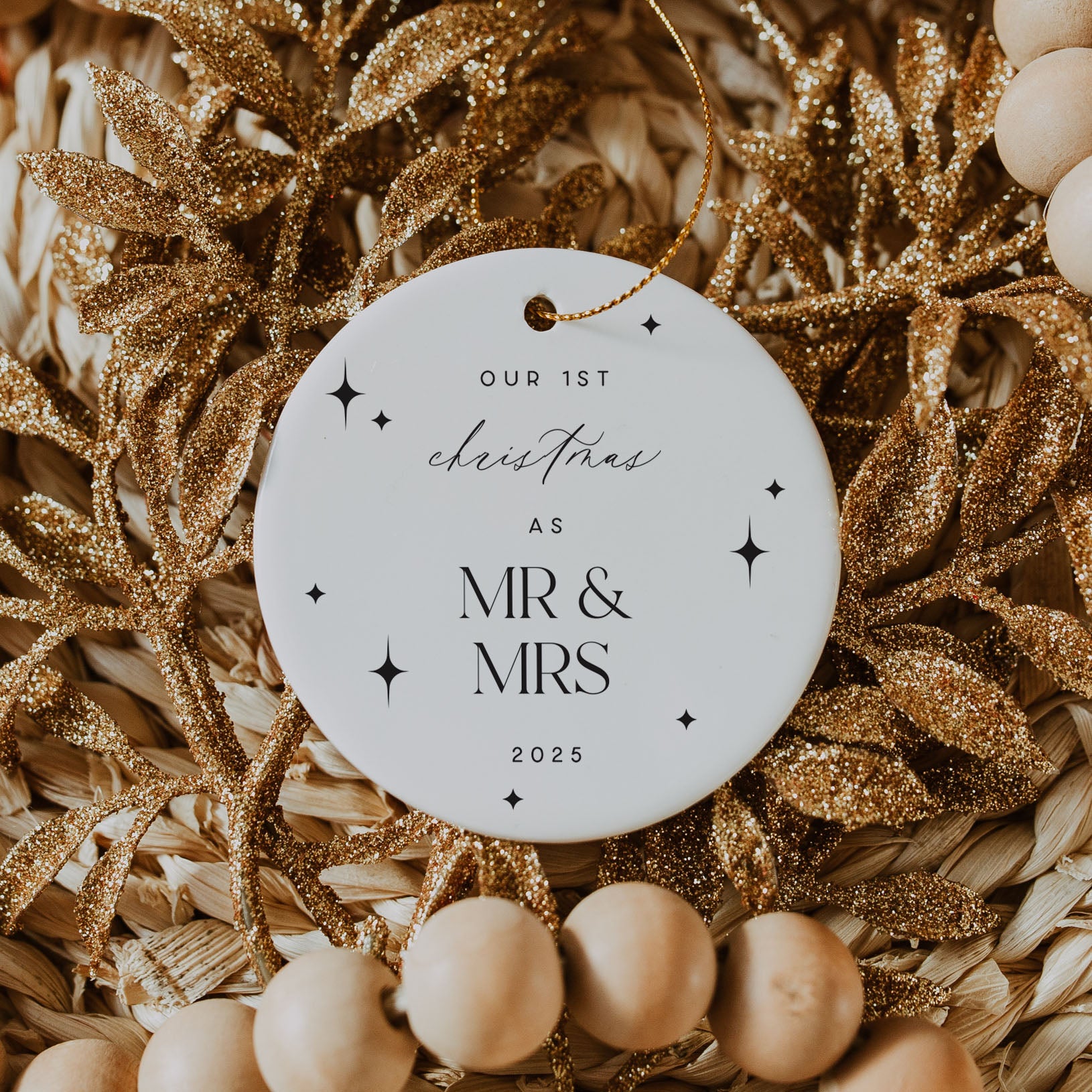 Decorative ornament with 'Our 1st Christmas as Mr & Mrs 2025' text on a gold and beige background.
