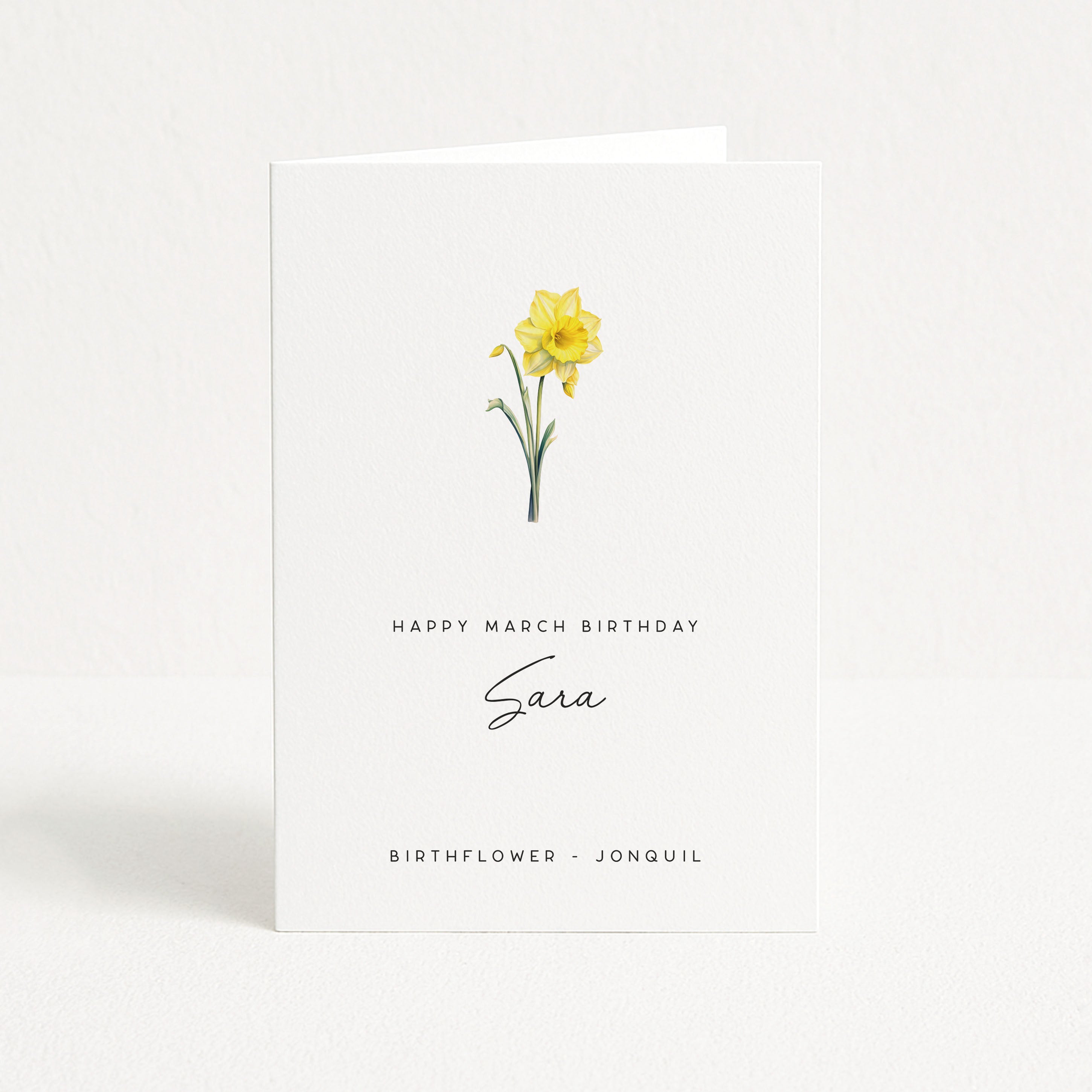 Greeting card with a yellow jonquil and text for March birthday on a white background