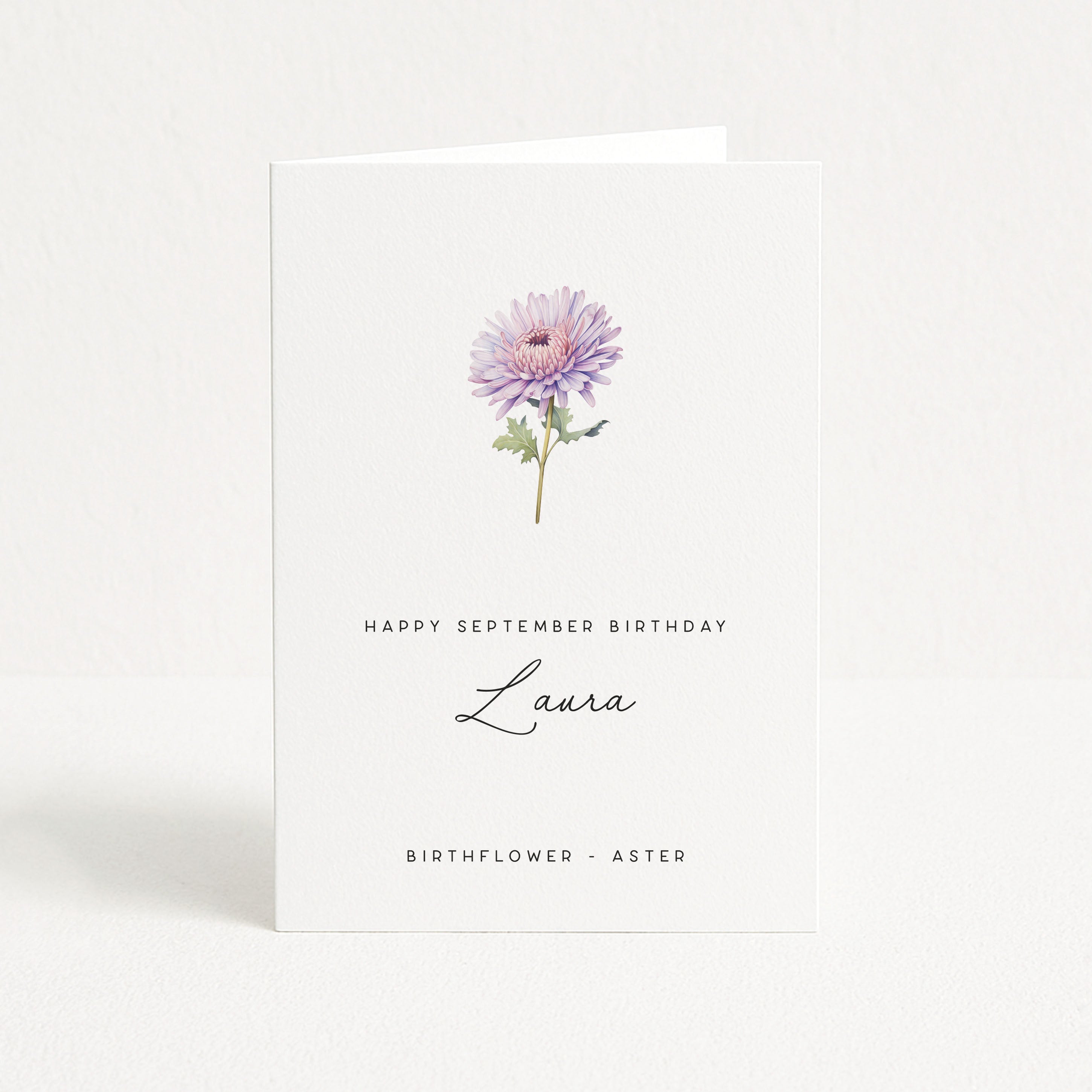 Greeting card with a purple aster flower and text for a September birthday, on a white background.