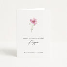 Greeting card with a pink flower illustration and birthday message on a white background