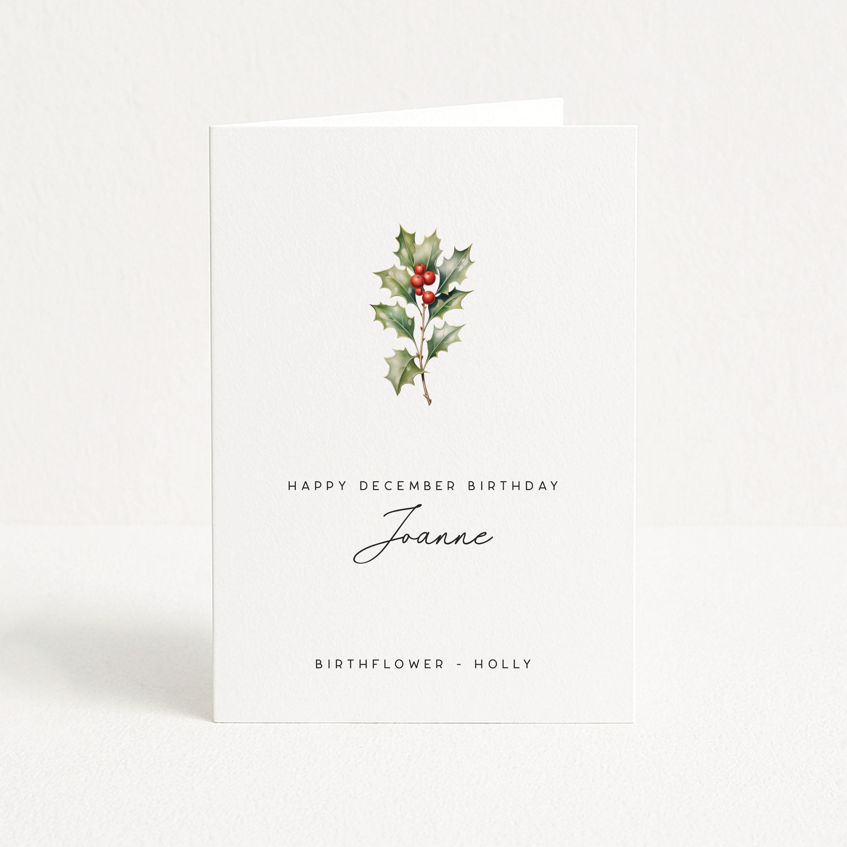 Greeting card with holly design and text on a white background