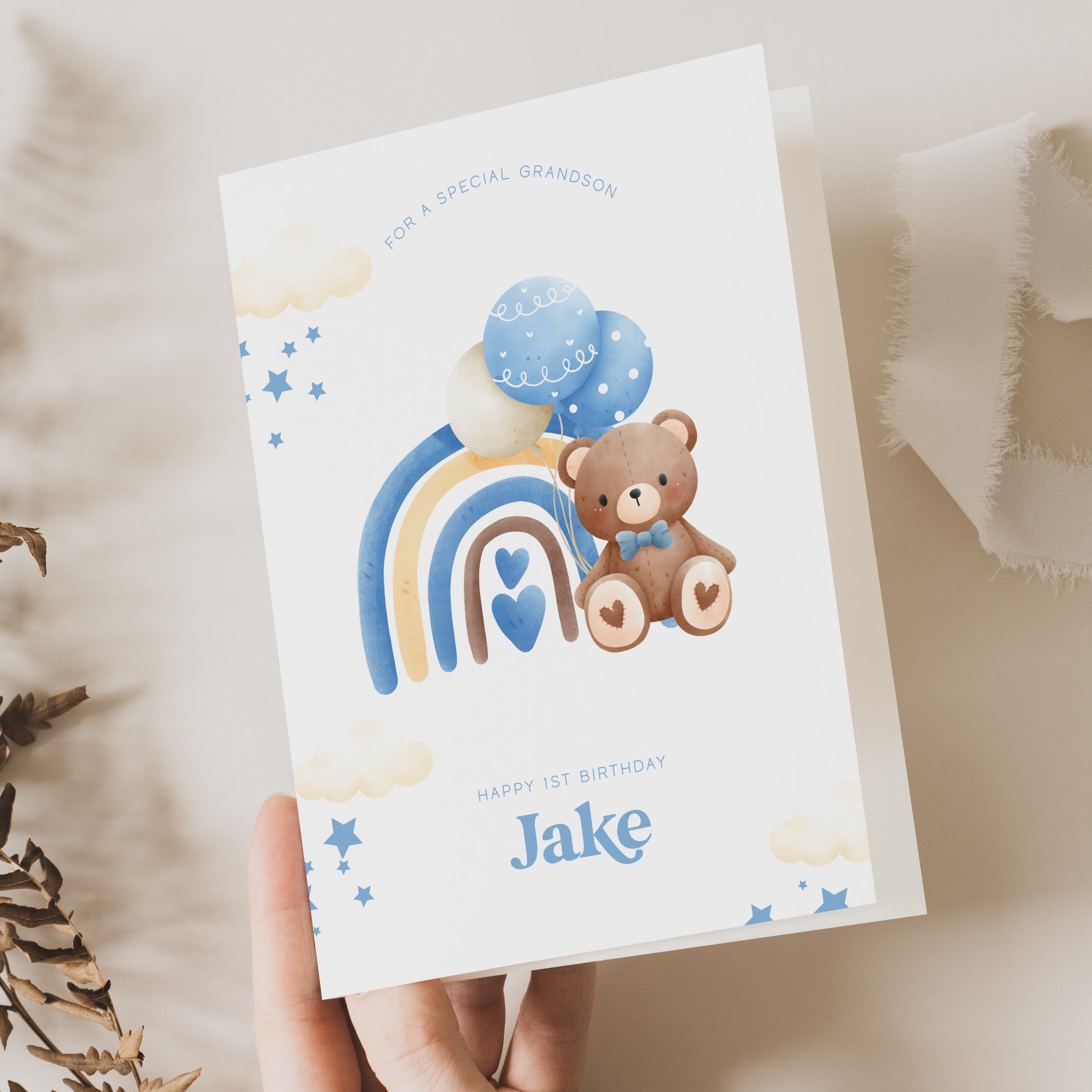 first birthday card for grandson, son, nephew, brother with a teddy bear and blue rainbow