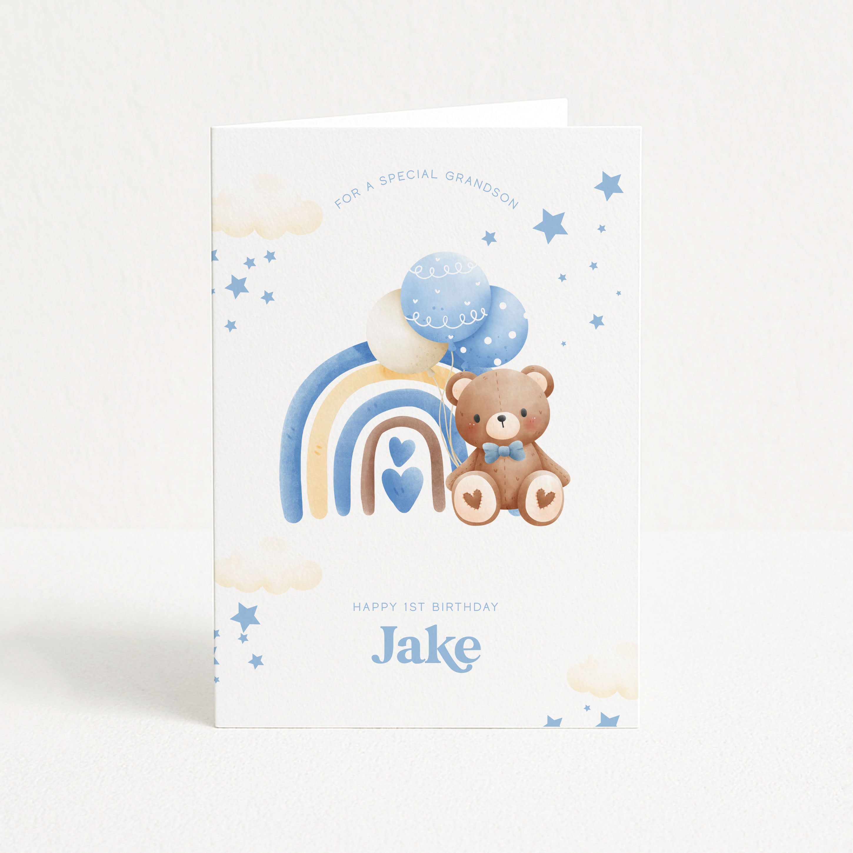 Greeting card with a teddy bear, rainbow, and balloons on a white background