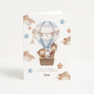 Greeting card with animals in a hot air balloon on a white background