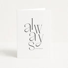 White card with black text 'always and forever' on a white background