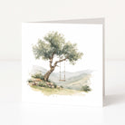 Greeting card with a tree and swing in a scenic landscape