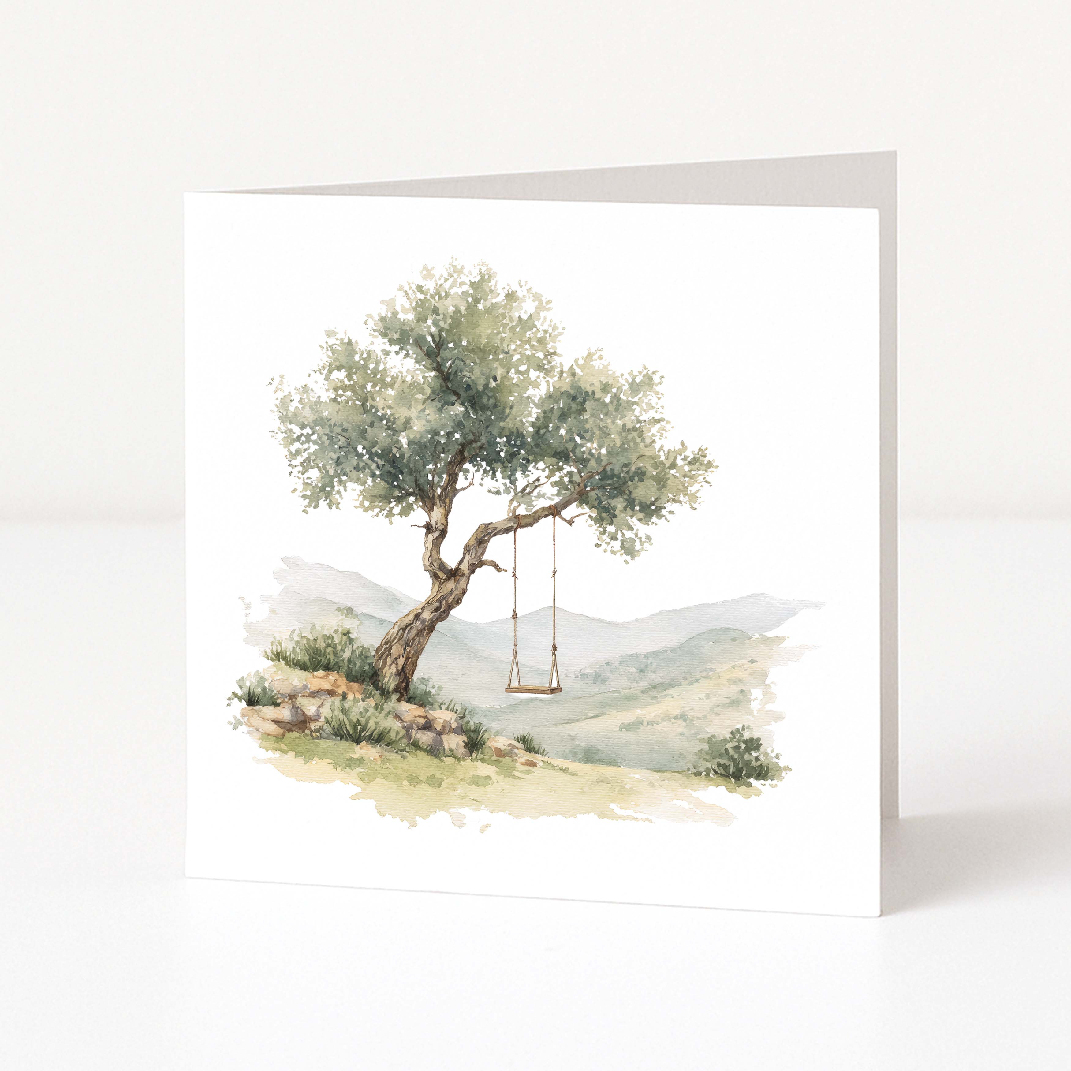 Greeting card with a tree and swing in a scenic landscape