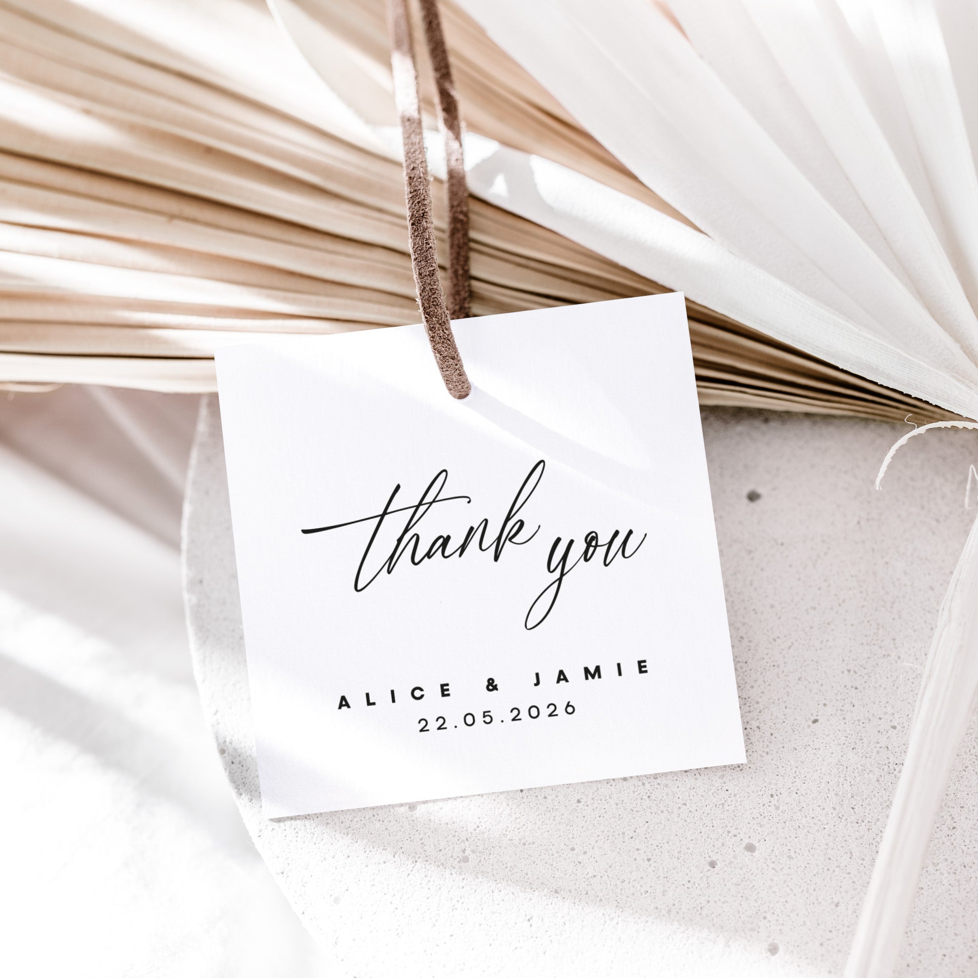 White card with 'thank you' message and date, hanging on dried plants.