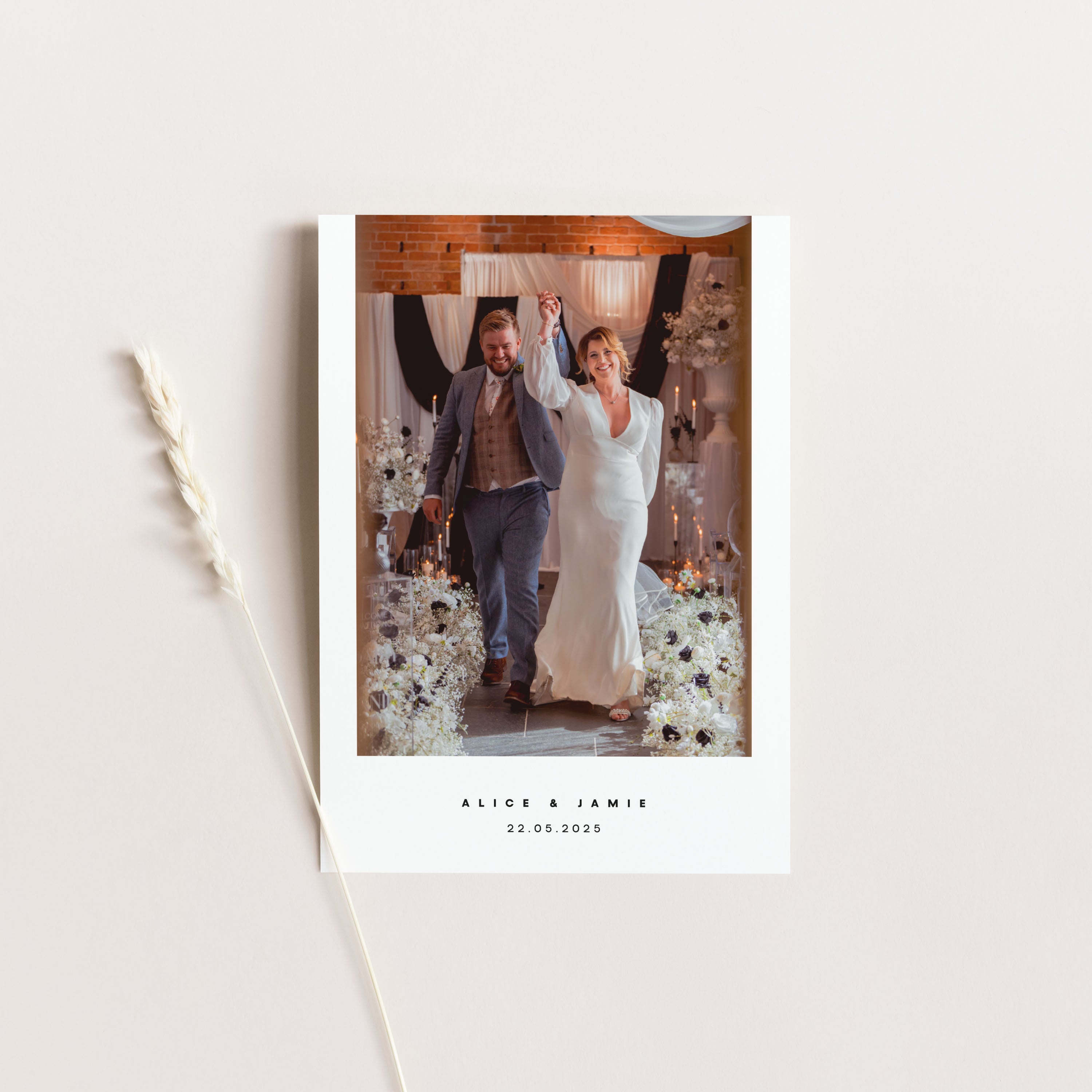 Wedding photo card with a couple in a decorated room, featuring the names 'Alice & Jamie' and wedding date