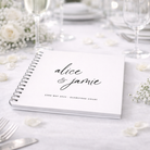 Guestbook with 'alice & jamie' on a table setting with flowers and cutlery