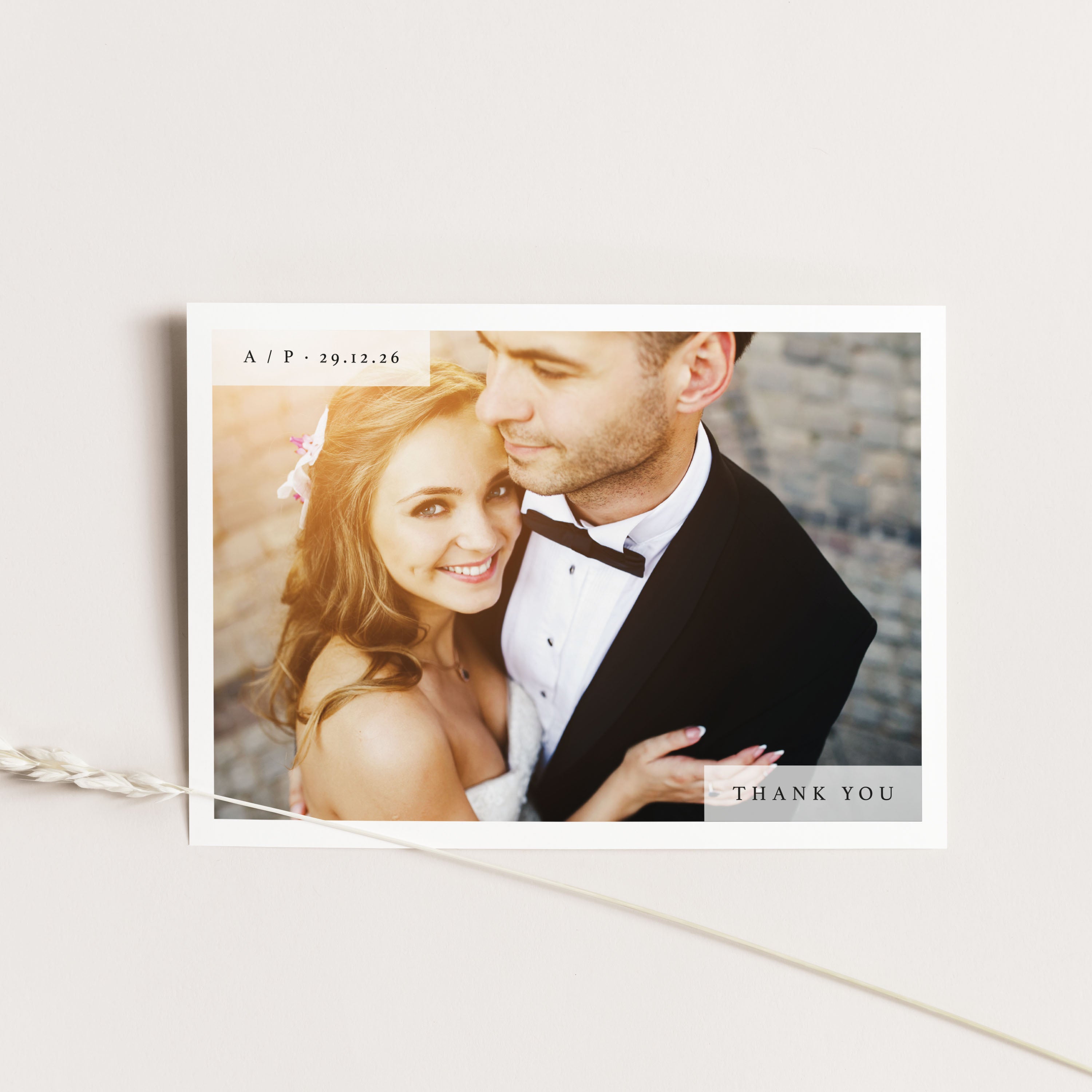 Wedding thank you card with a couple embracing on a light background