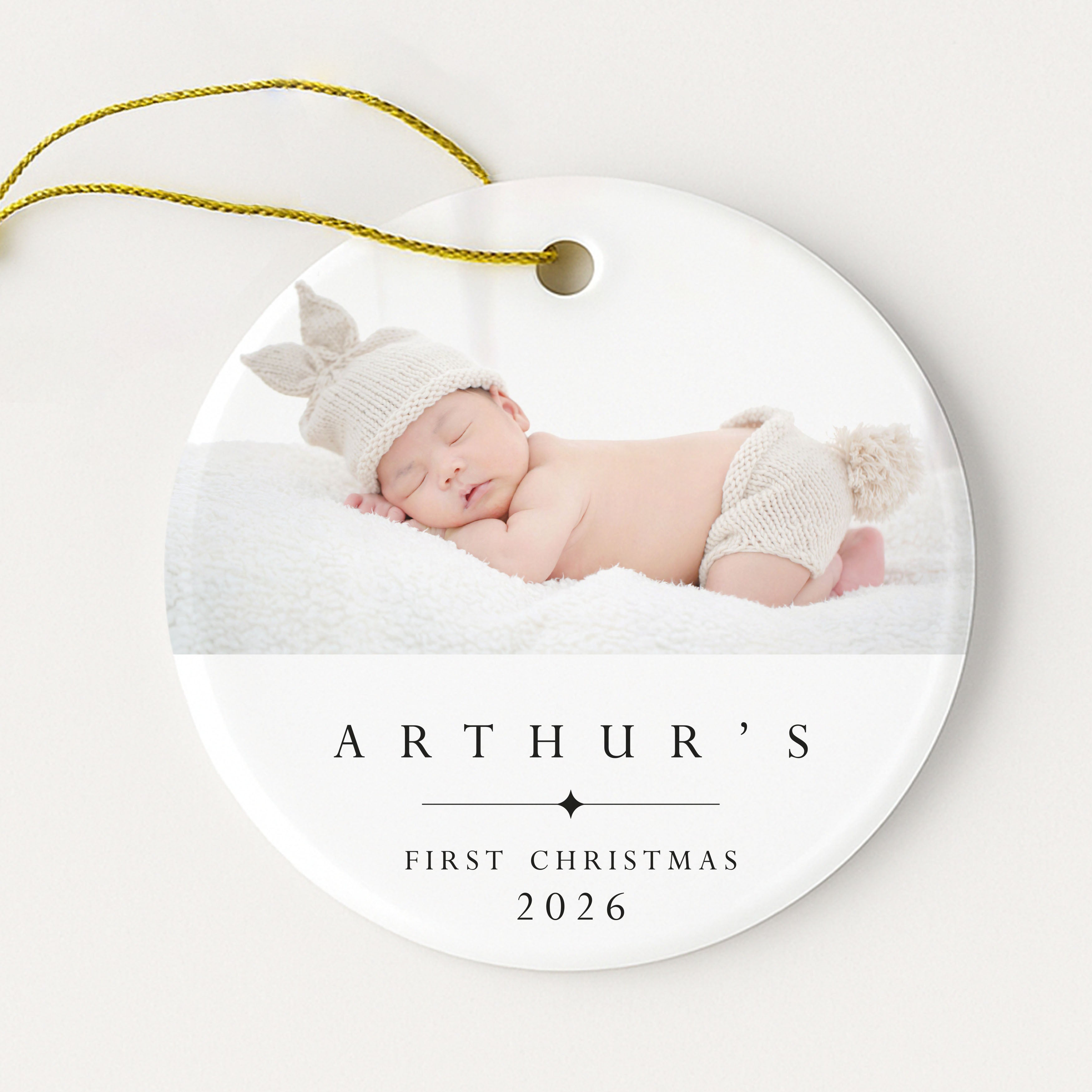 Round ornament with a photo of a baby and 'Arthur's First Christmas 2026' text on a white background.