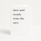 Birthday card with 'slow and steady wins the race' text on a white background