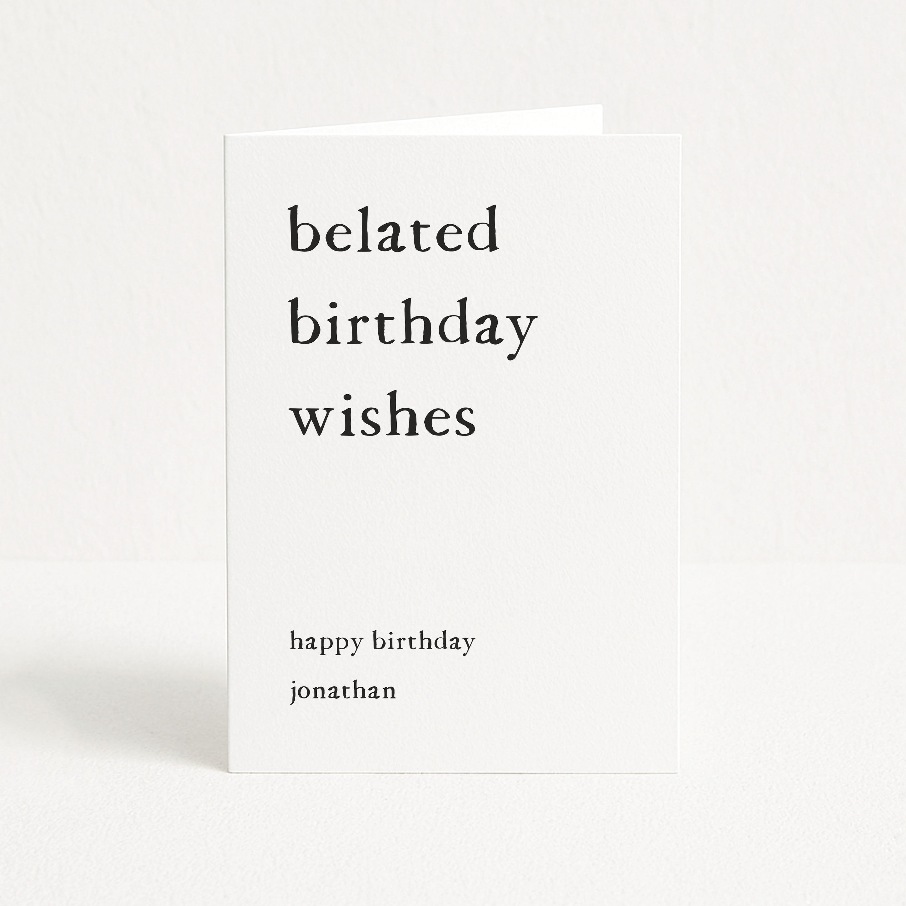 Greeting card with 'belated birthday wishes' text on a white background