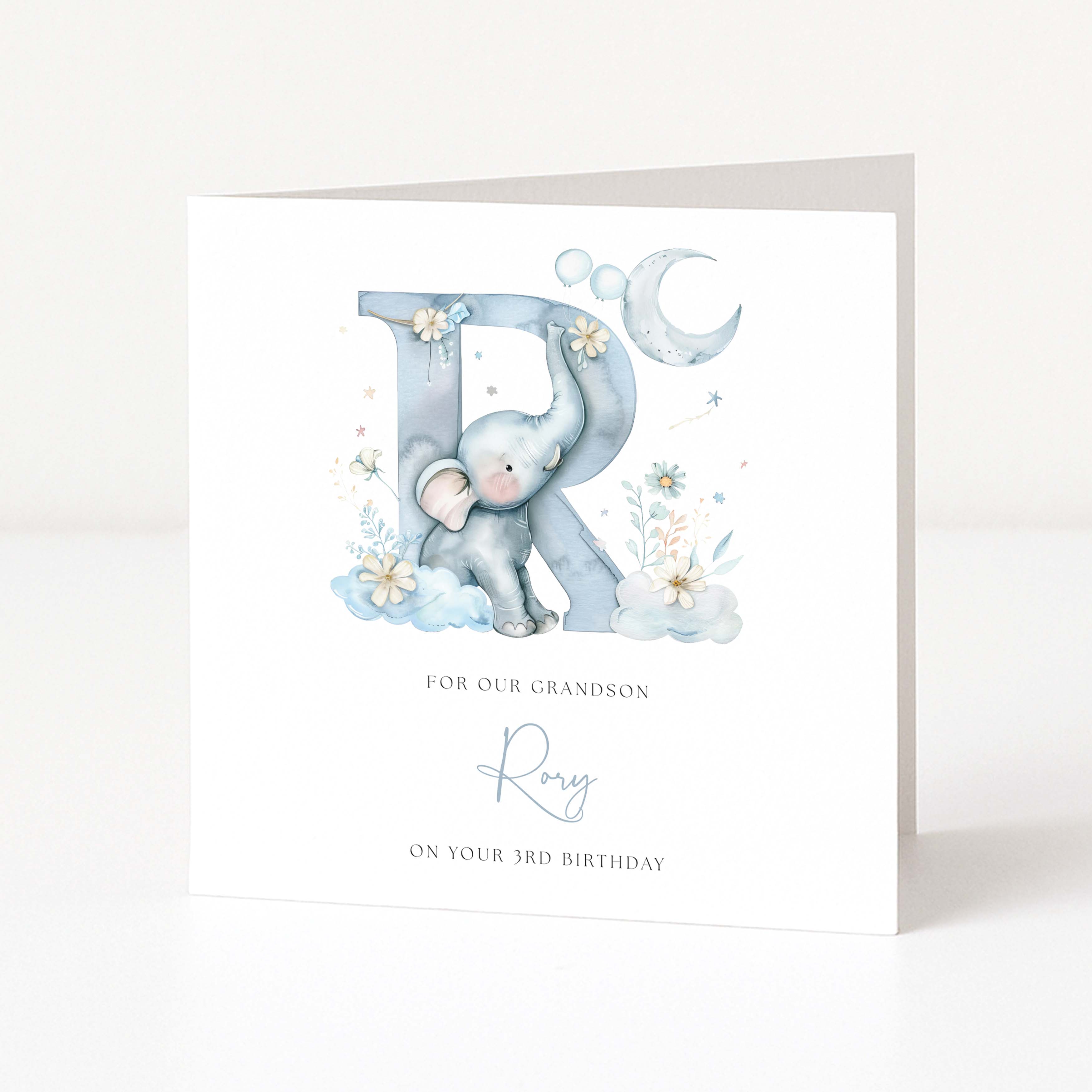 Greeting card with a blue elephant holding a letter 'R' on a white background
