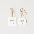 Two white tags with 'Thank you L/M' text on a light beige background