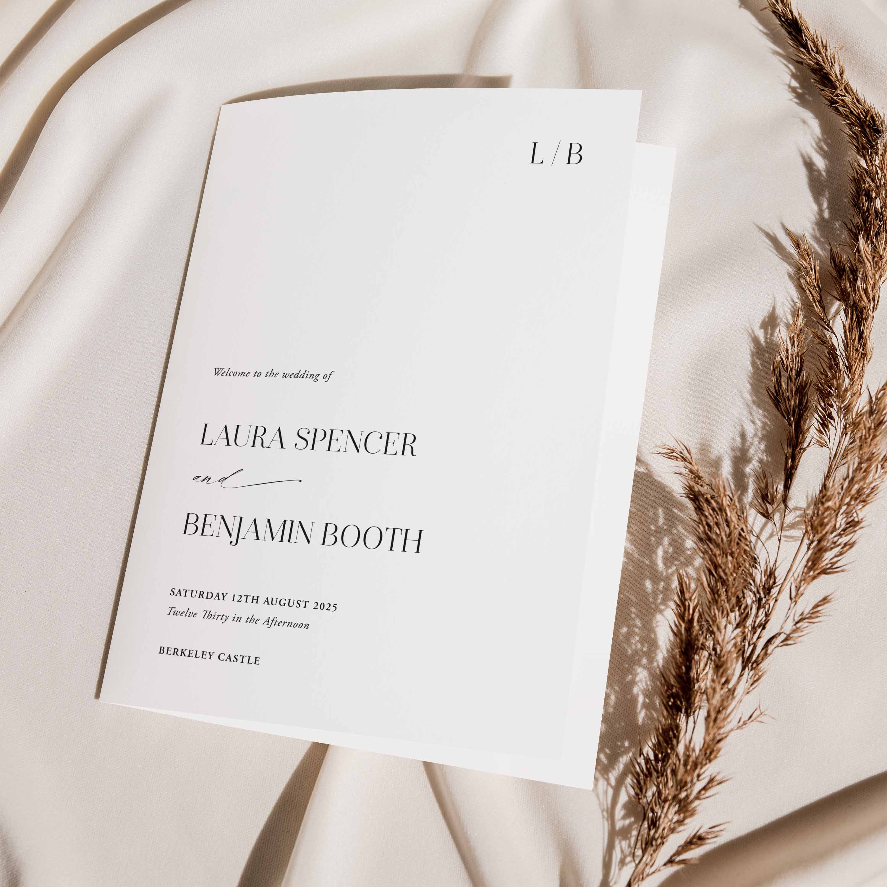 Wedding Order of Service booklet on a fabric background with dried flowers