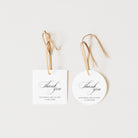 Two 'thank you' favour tags with ribbons on a white background