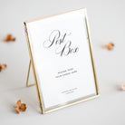 Gold-framed sign with 'Post Box' text on a light background