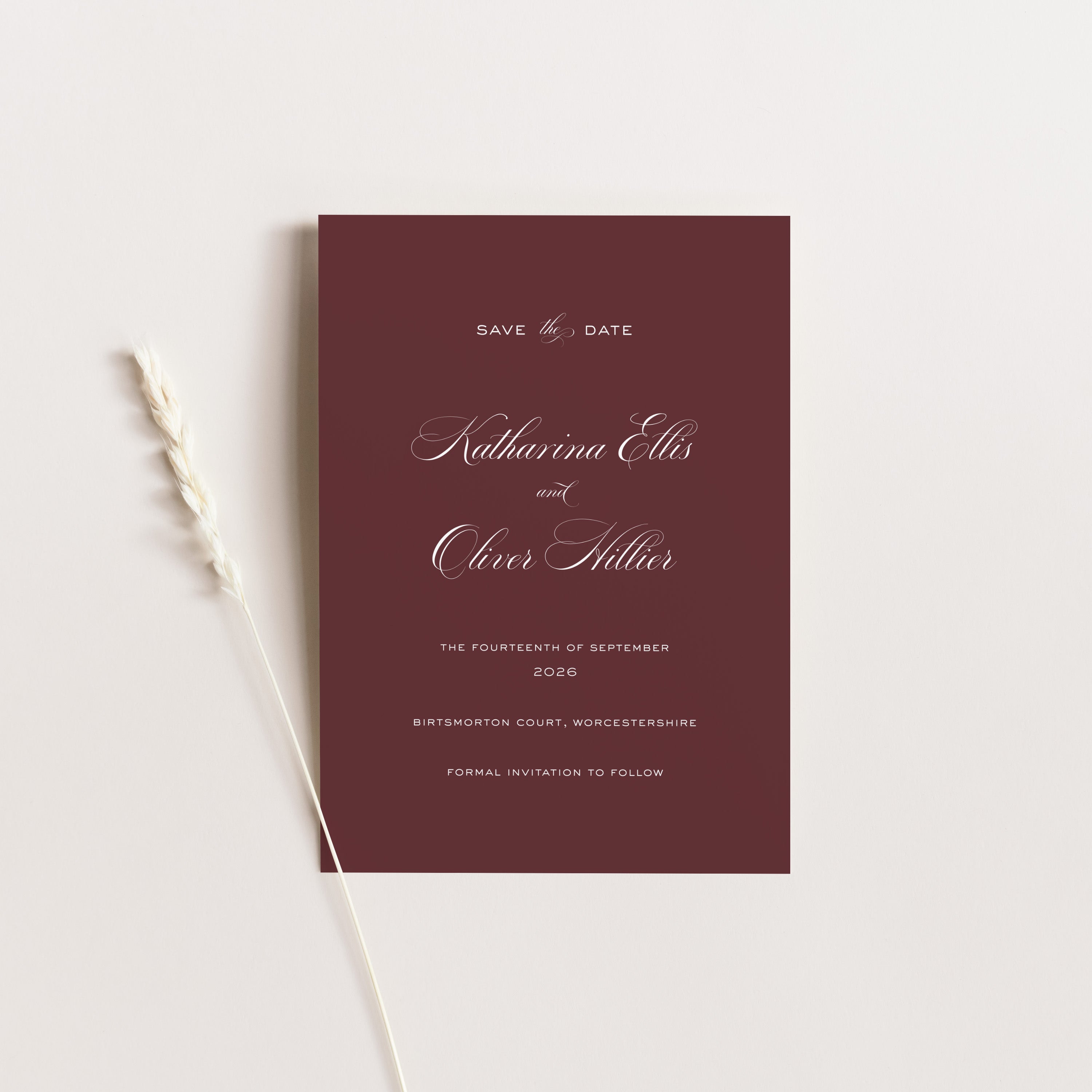 Maroon save the date card with white text on a light gray background