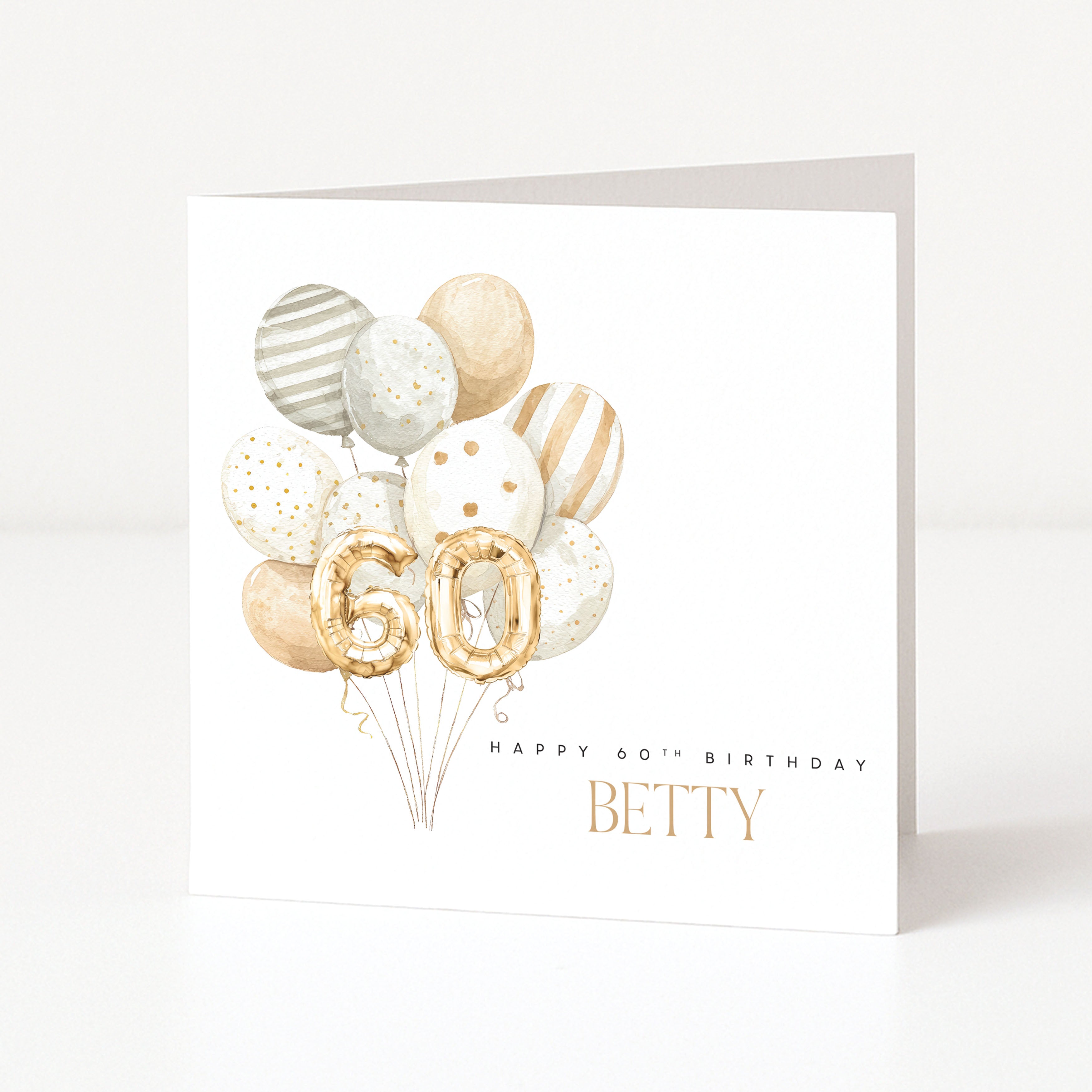 Personalised 60th birthday card with gold number balloons, balloon arrangement and recipient name on the front.