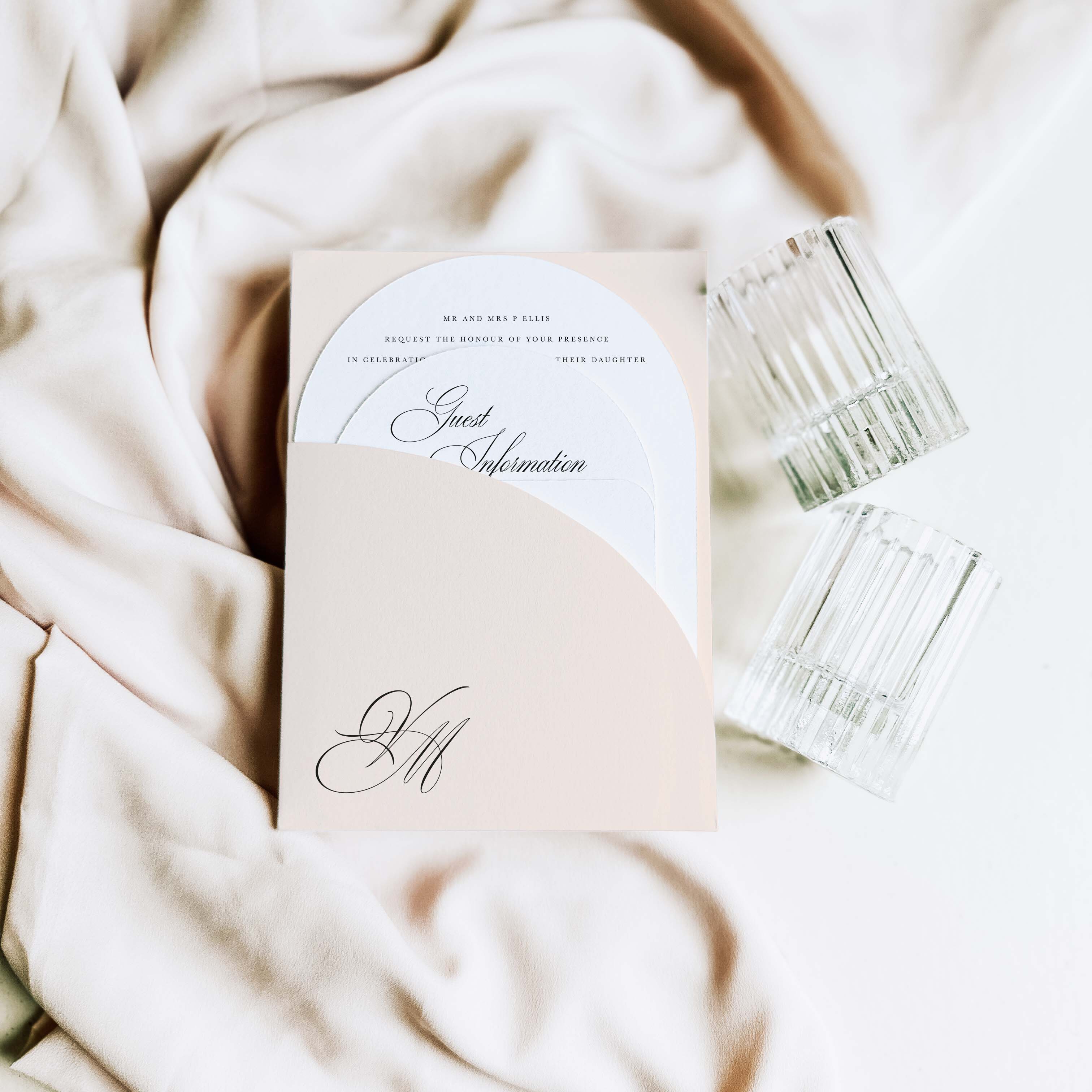 Invitation card with a glass of water on a soft fabric background