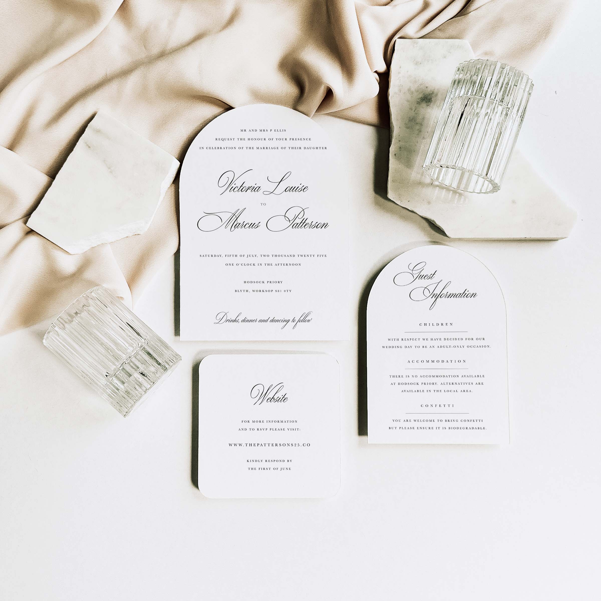 Set of elegant wedding invitations on a soft fabric background