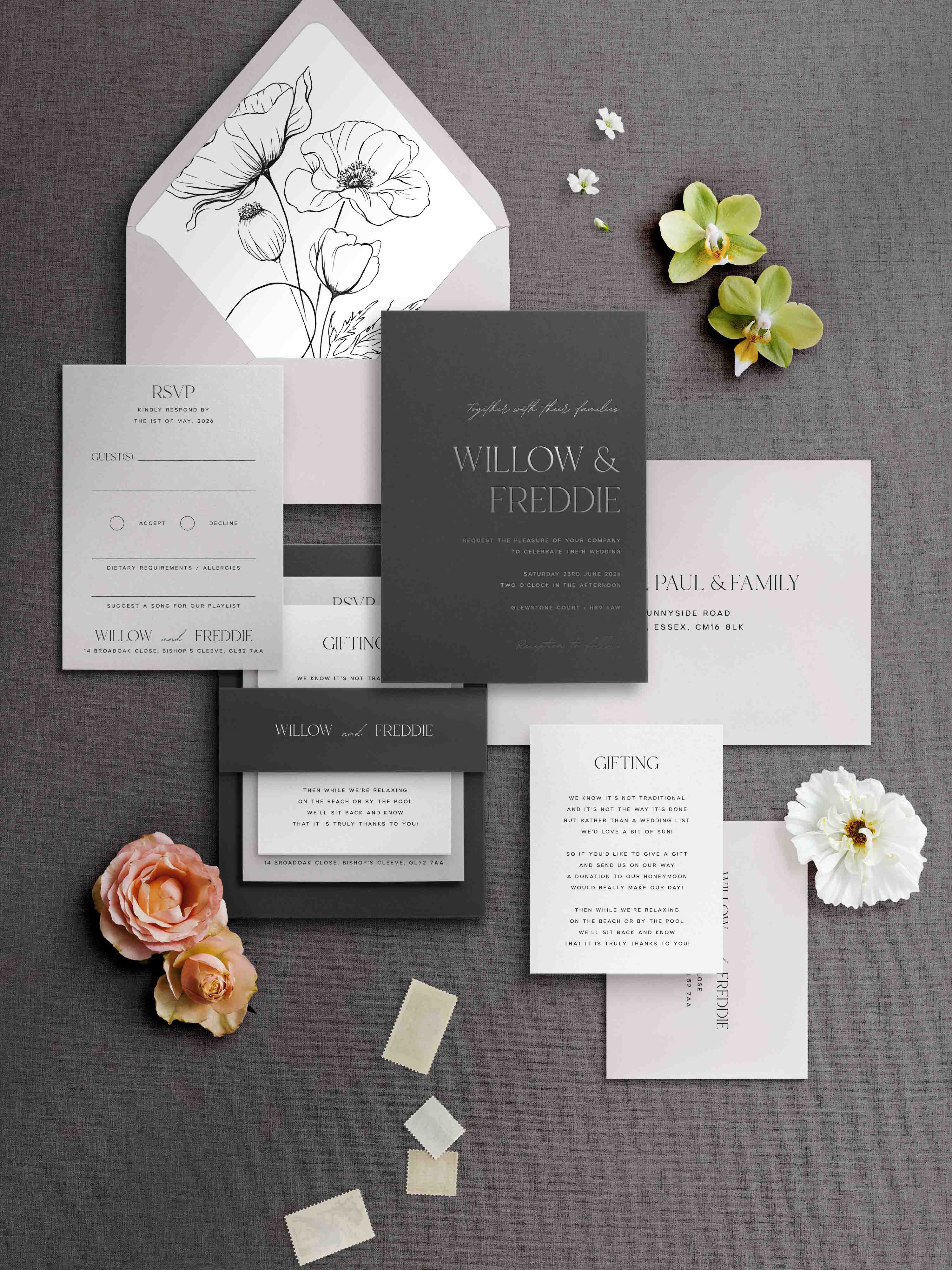Wedding invitation set with floral elements on a gray background
