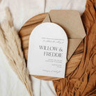 Wedding invitation card with brown envelope on a textured surface
