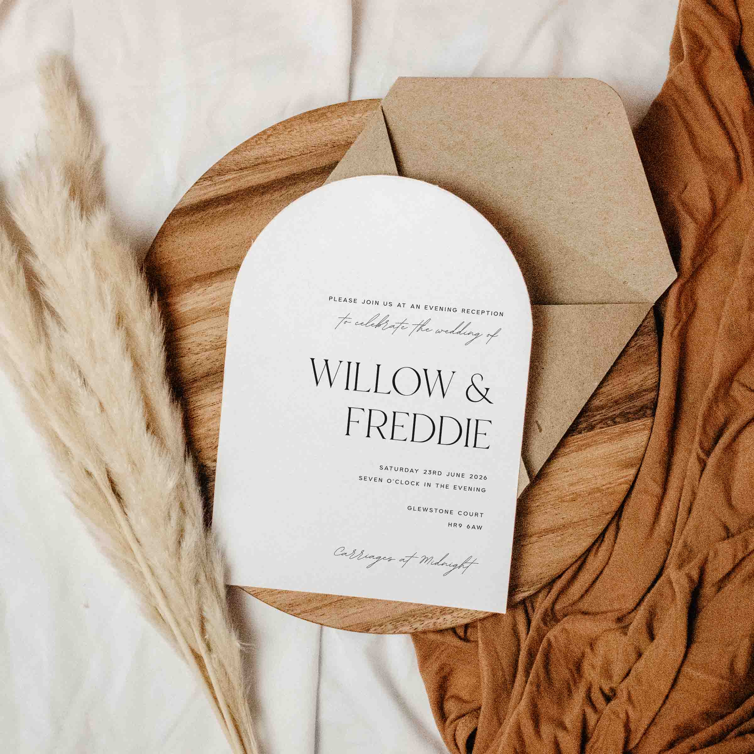 Wedding invitation card with brown envelope on a textured surface