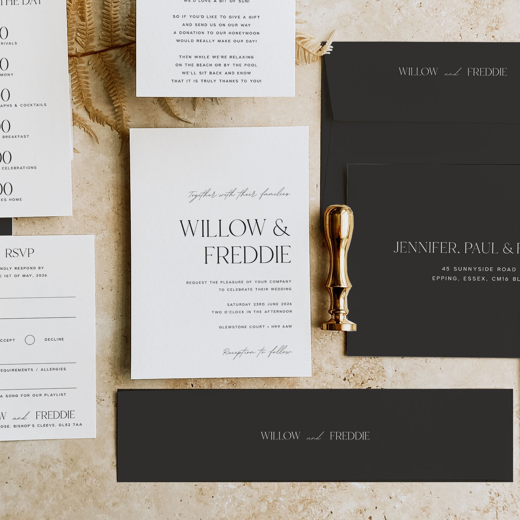 Wedding invitation set with RSVP card, envelope, and gold seal on a textured surface.