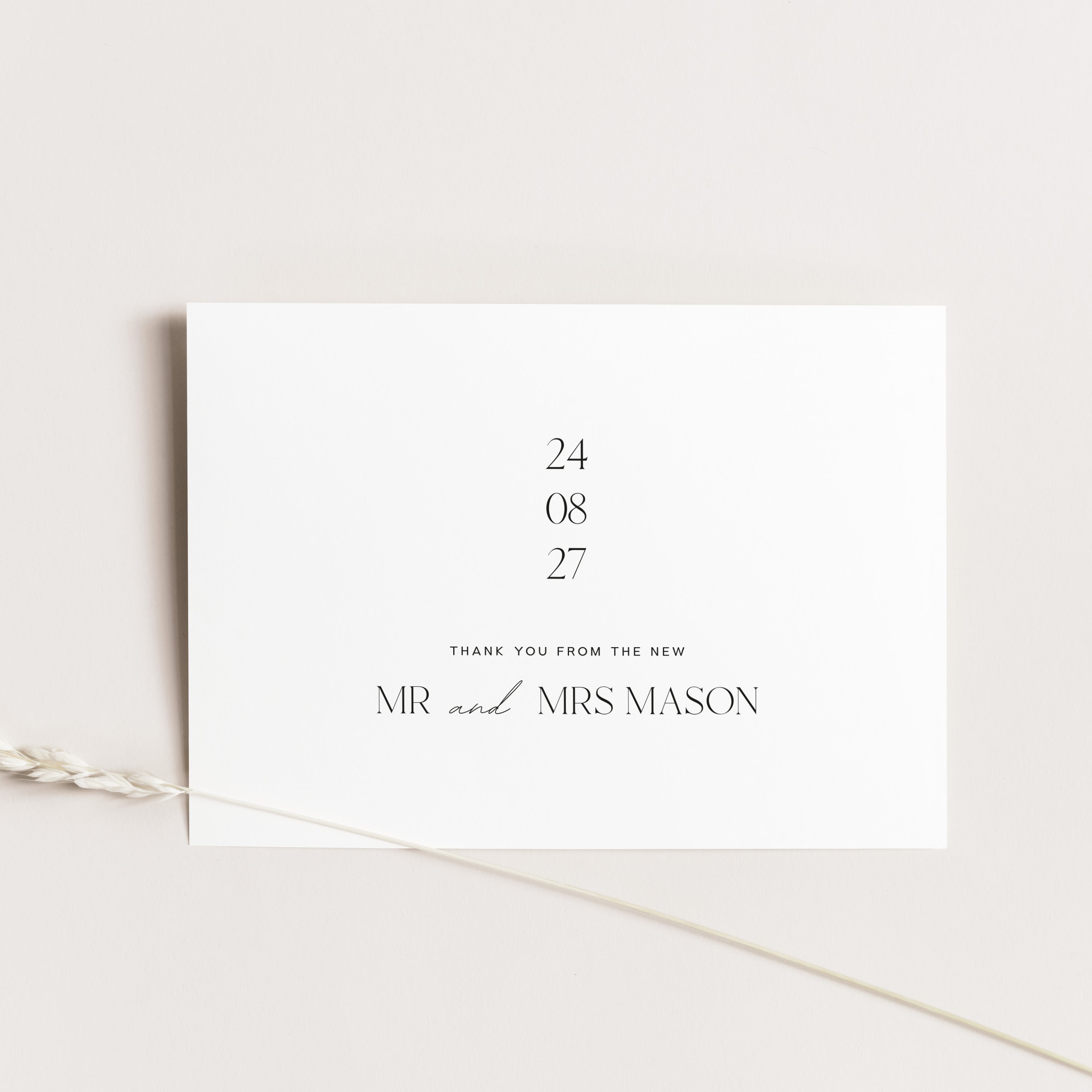 Wedding thank you card in white on a beige background