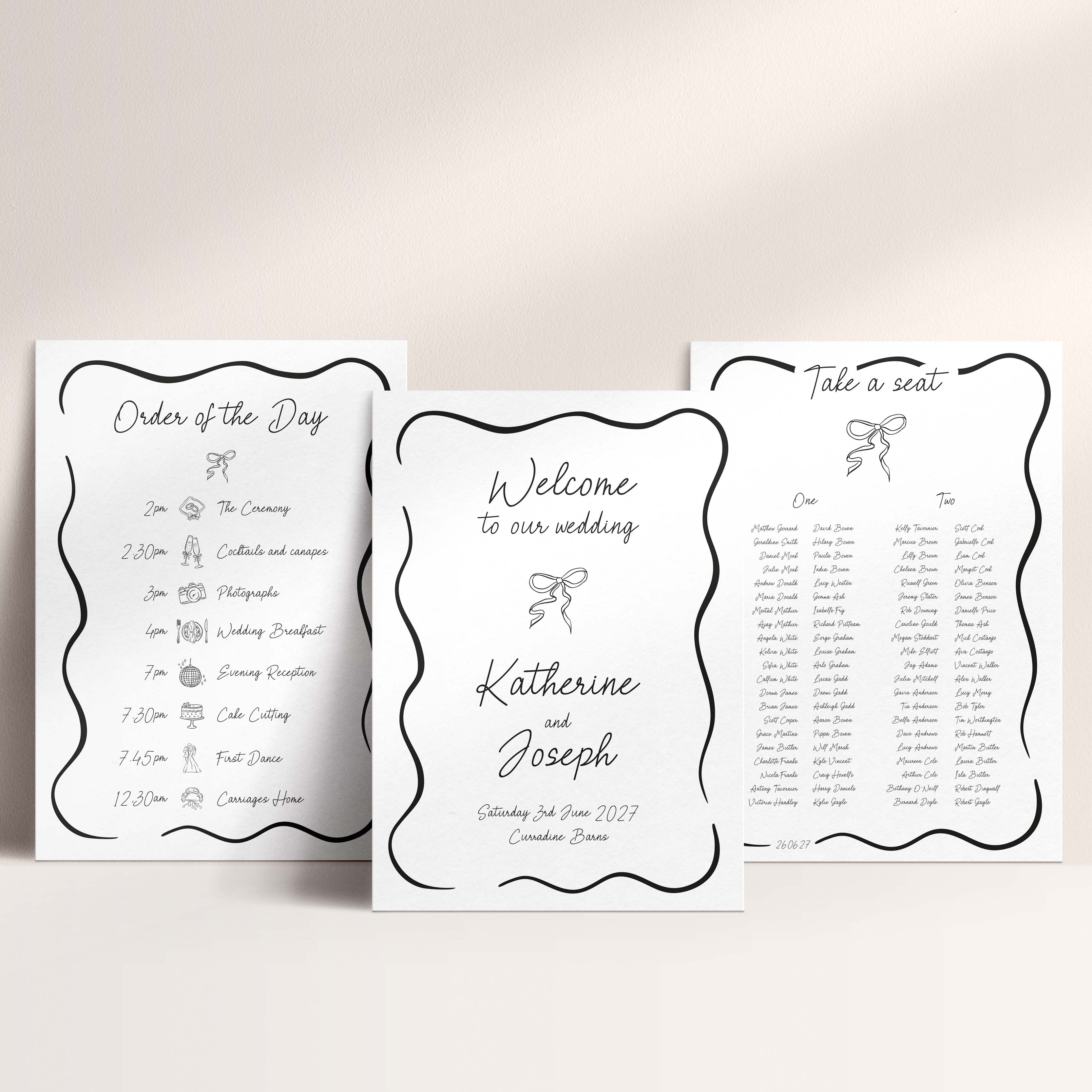 Three wedding signage boards arranged on a light beige background. The centre reads 'Welcome to our wedding' with the names Katherine and Joseph and the date Saturday, 26 June 2027, while the side cards show 'Order of the Day' and 'Take a seat' with black decorative borders and small illustrations.